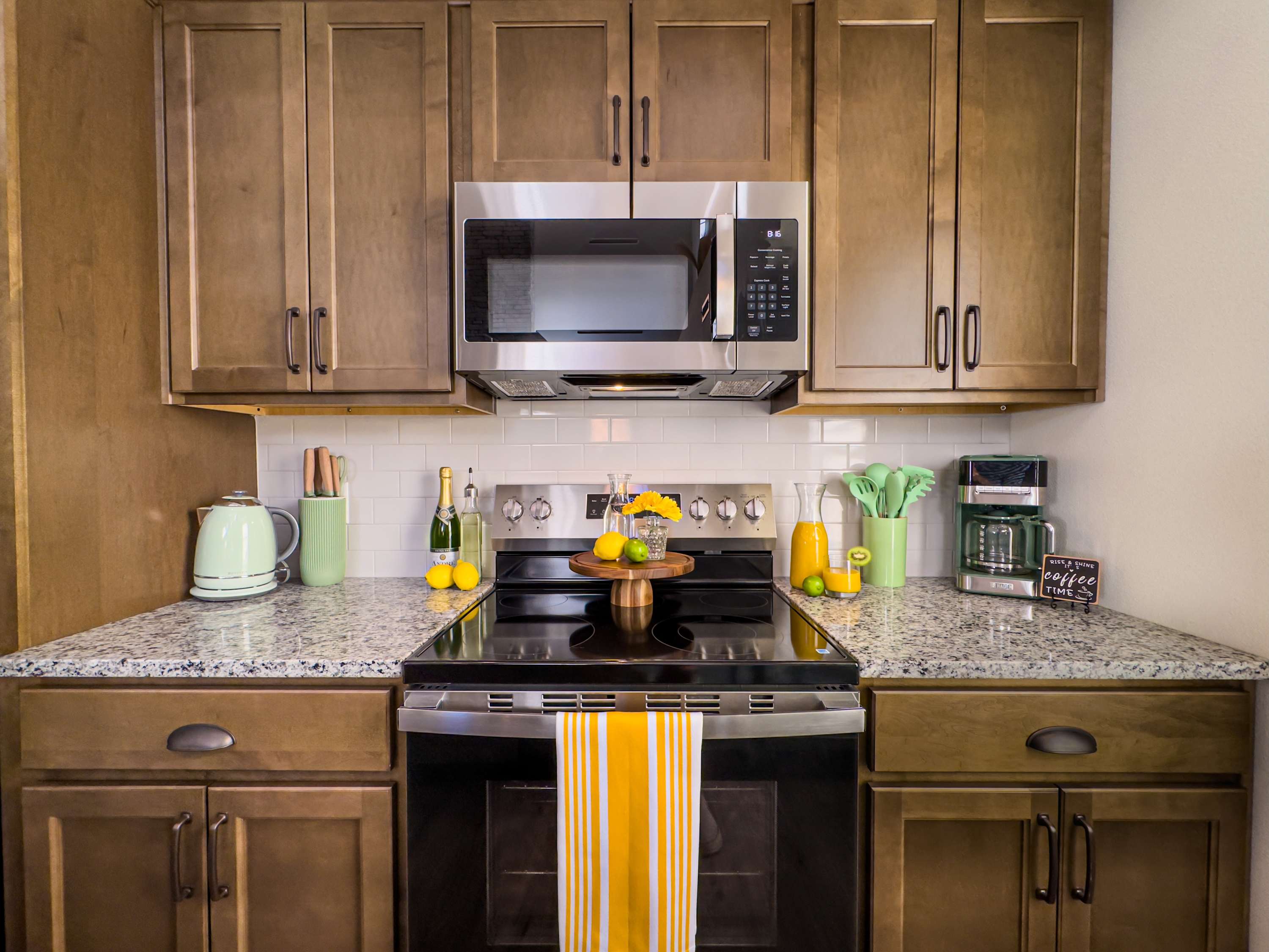 The kitchen features gleaming granite countertops, high-end stainless steel appliances, and all the cookware and gadgets you need to craft meals for your family and friends.