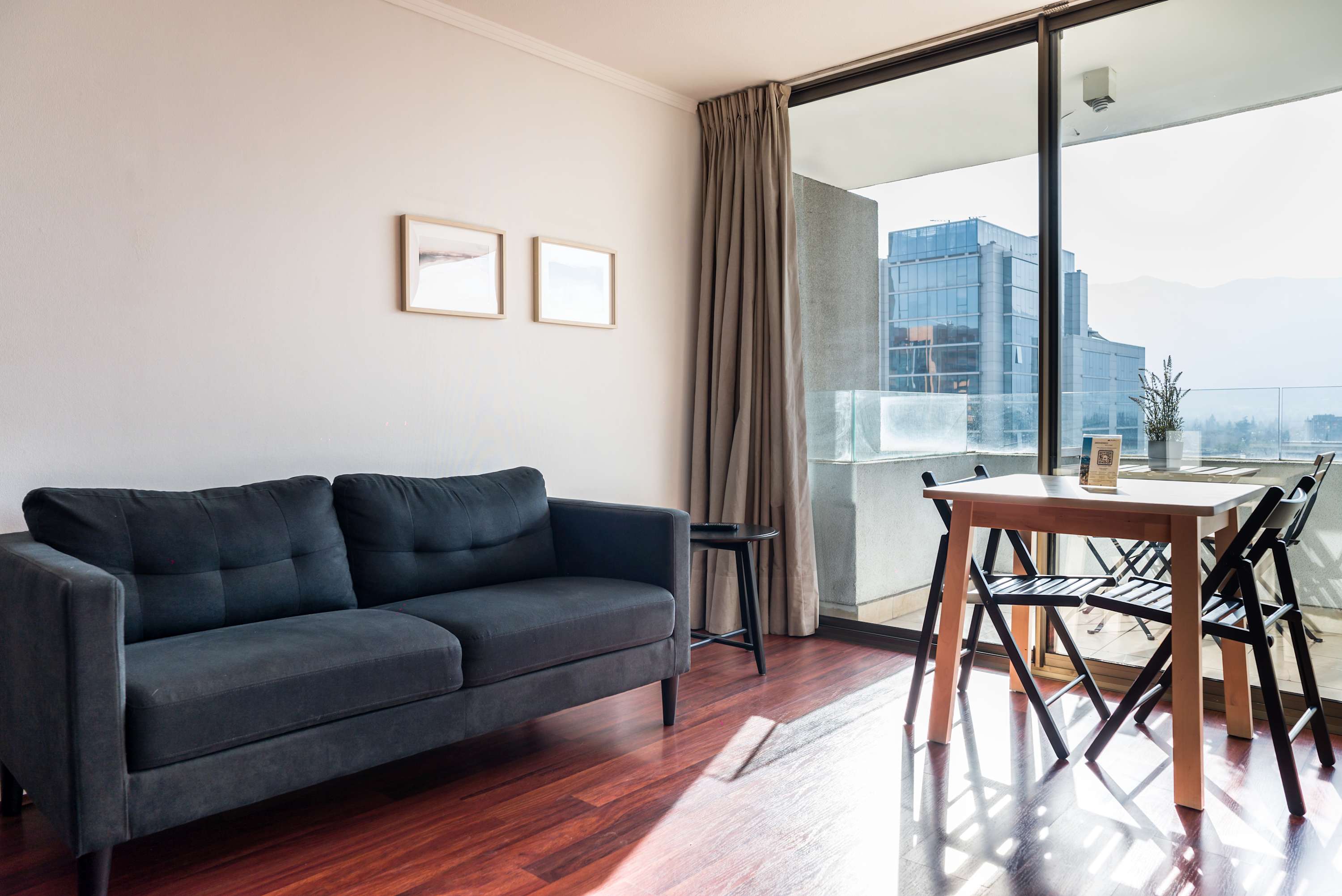 Bright and cozy living space with balcony access, perfect for relaxing and enjoying city views.