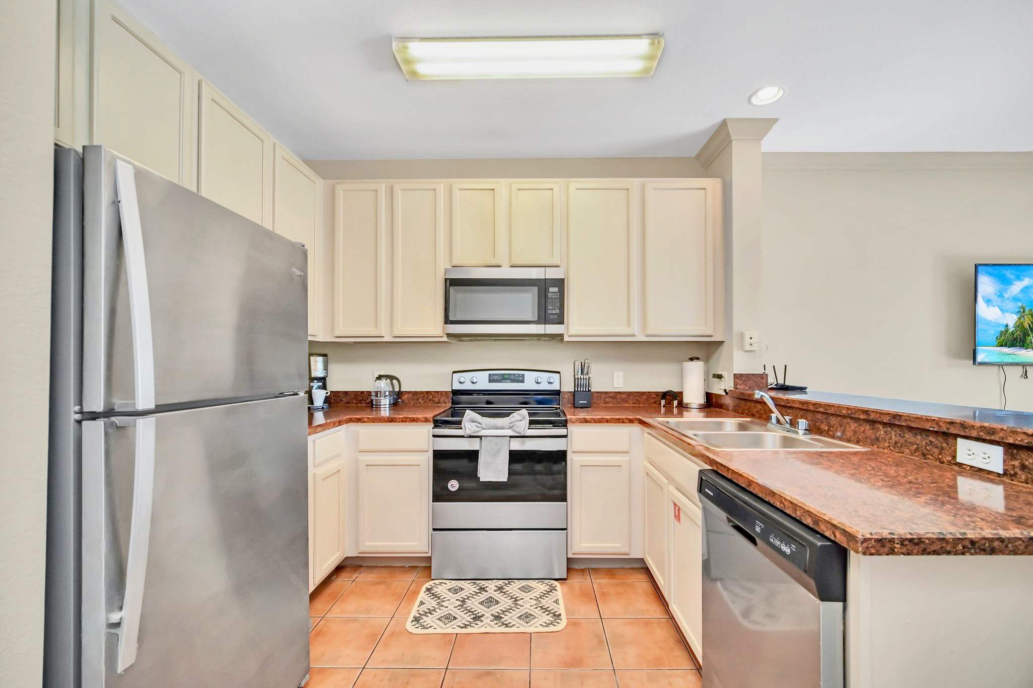 Fully equipped kitchen with silver appliances