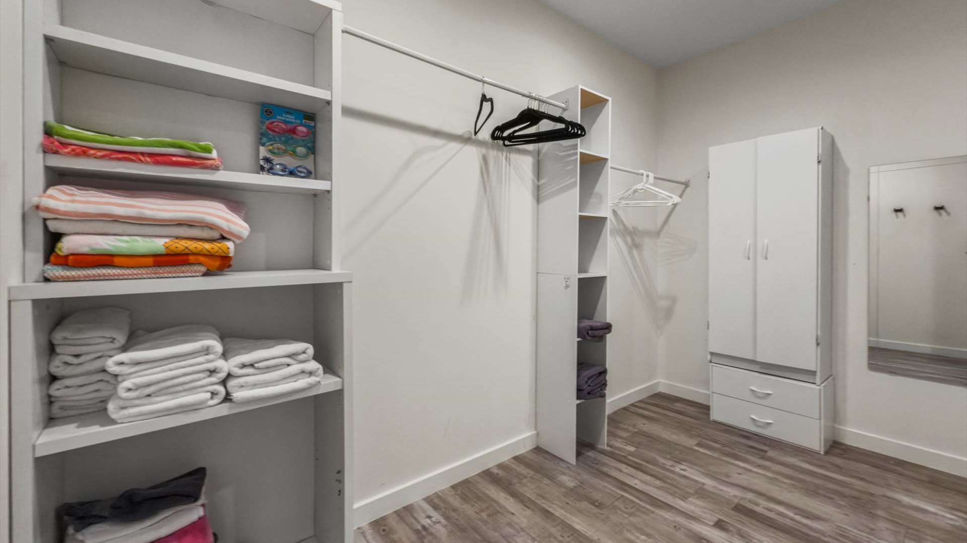 Spacious walk-in closet with towels and bedding