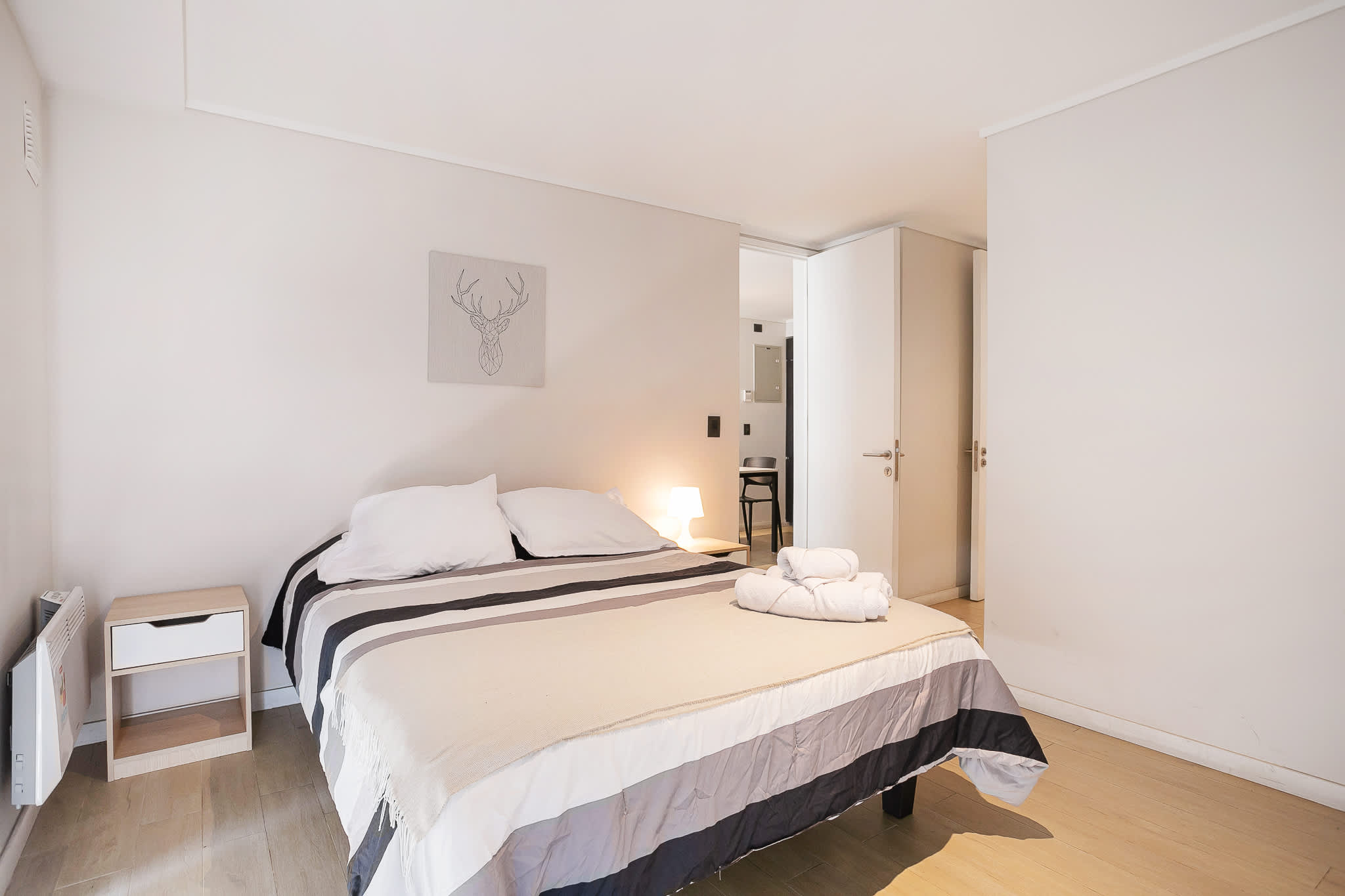 Relax in this cozy bedroom with soft lighting and stylish decor, perfect for a restful stay.