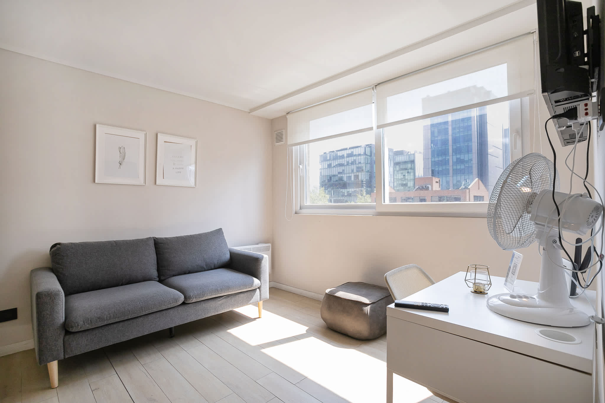 Bright and cozy living space with a city view, perfect for relaxation or work.