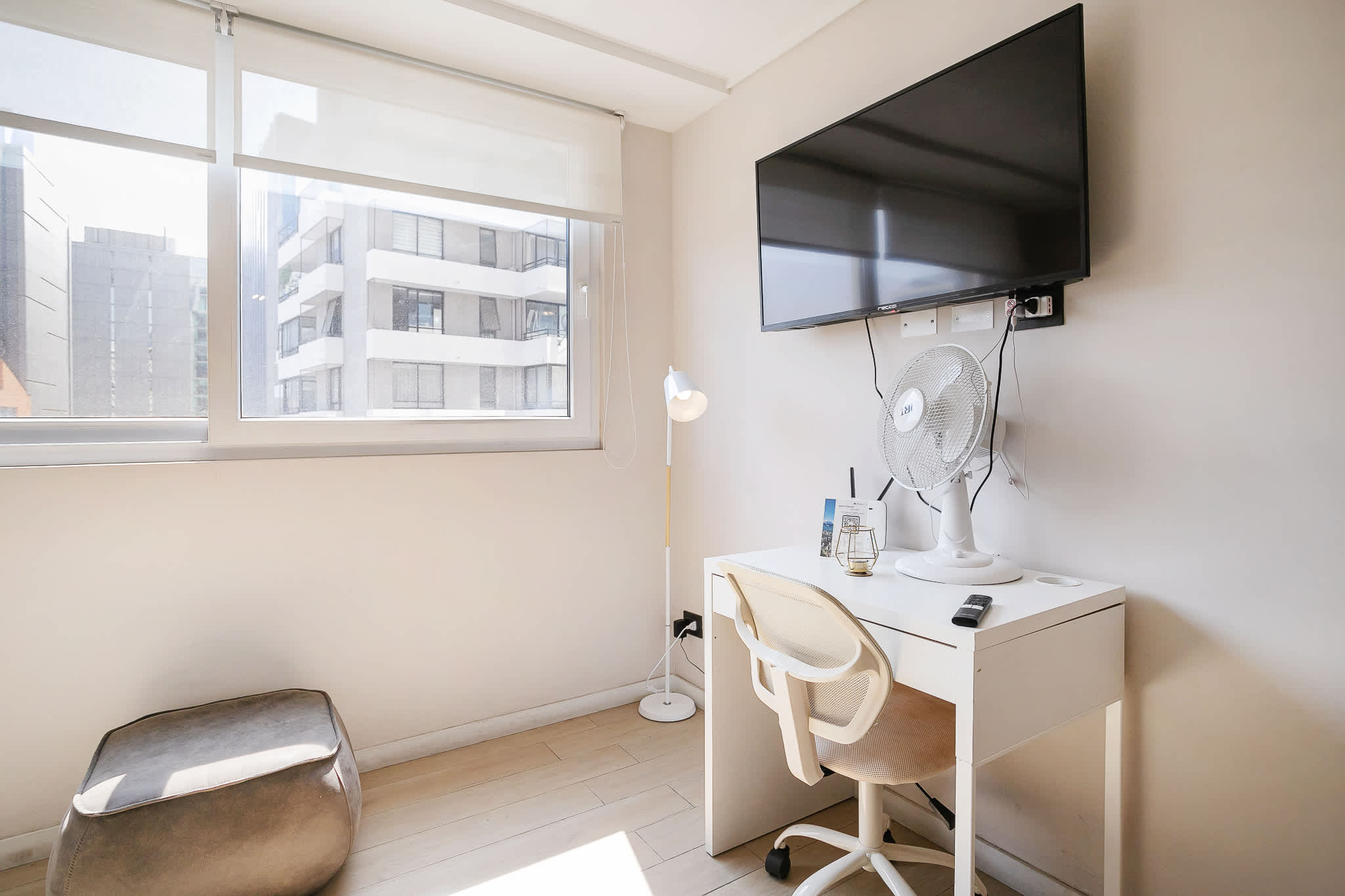 Bright and cozy workspace with natural light and modern amenities, perfect for remote work or relaxation.
