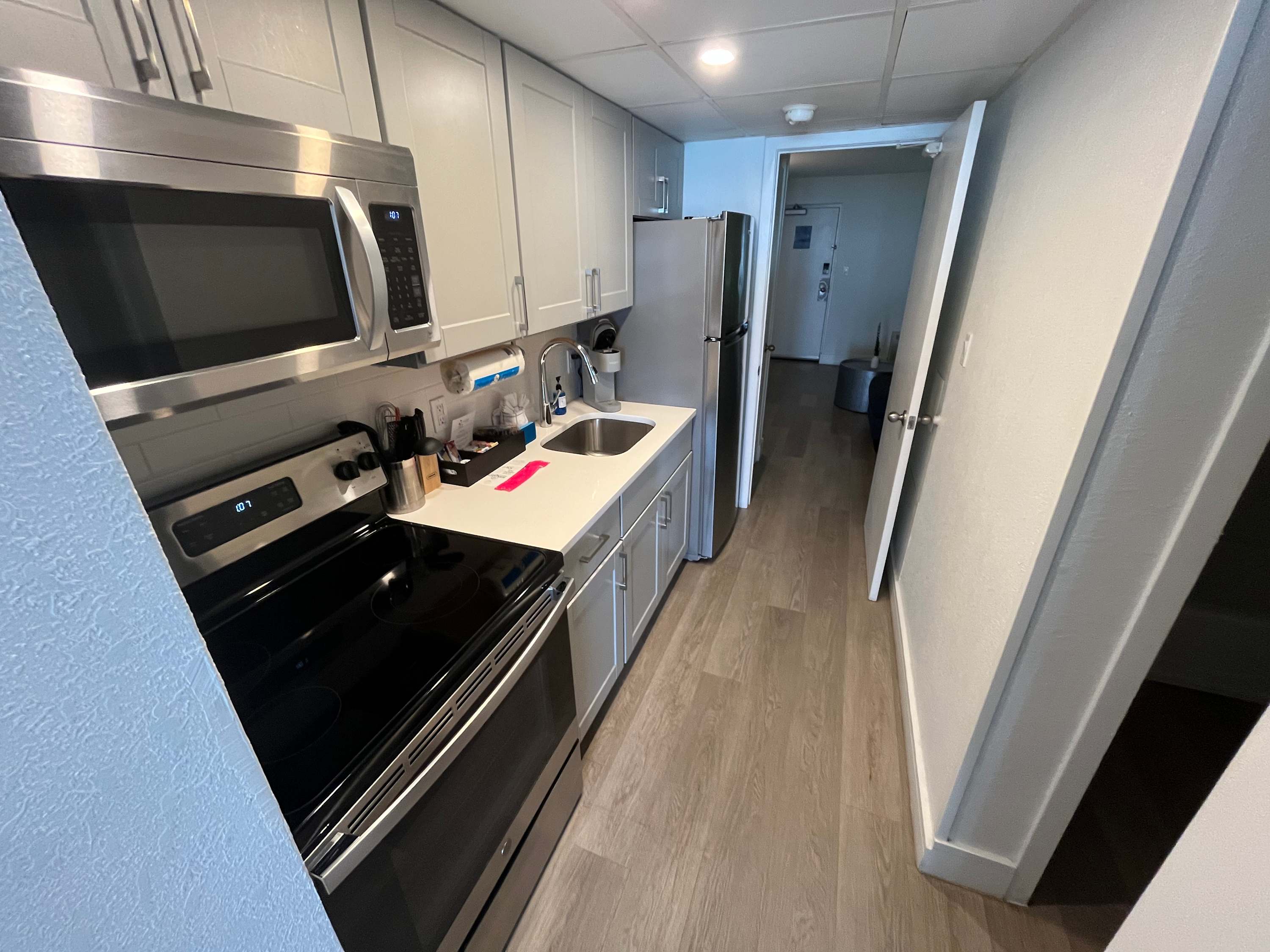 Enjoy the convenience of a fully equipped modern kitchen, complete with stainless steel appliances, sleek cabinetry, and all the essentials to prepare your favorite meals during your stay.