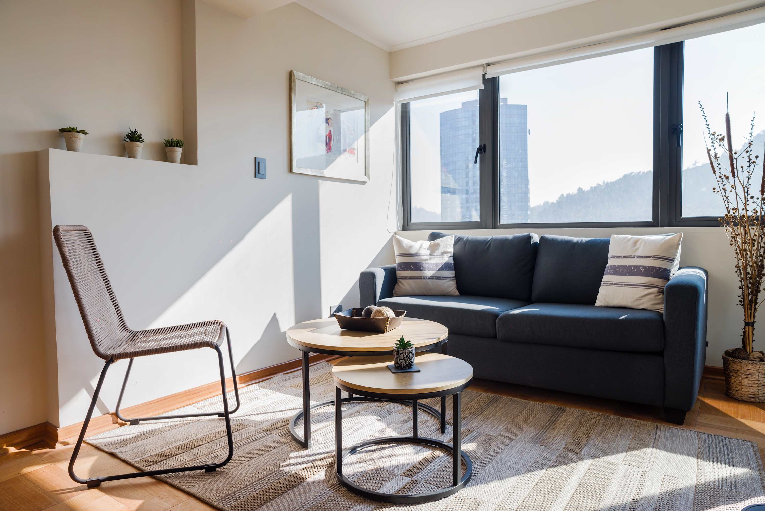 Relax in this sunlit living room with a stunning city view, perfect for unwinding after a day of exploring.