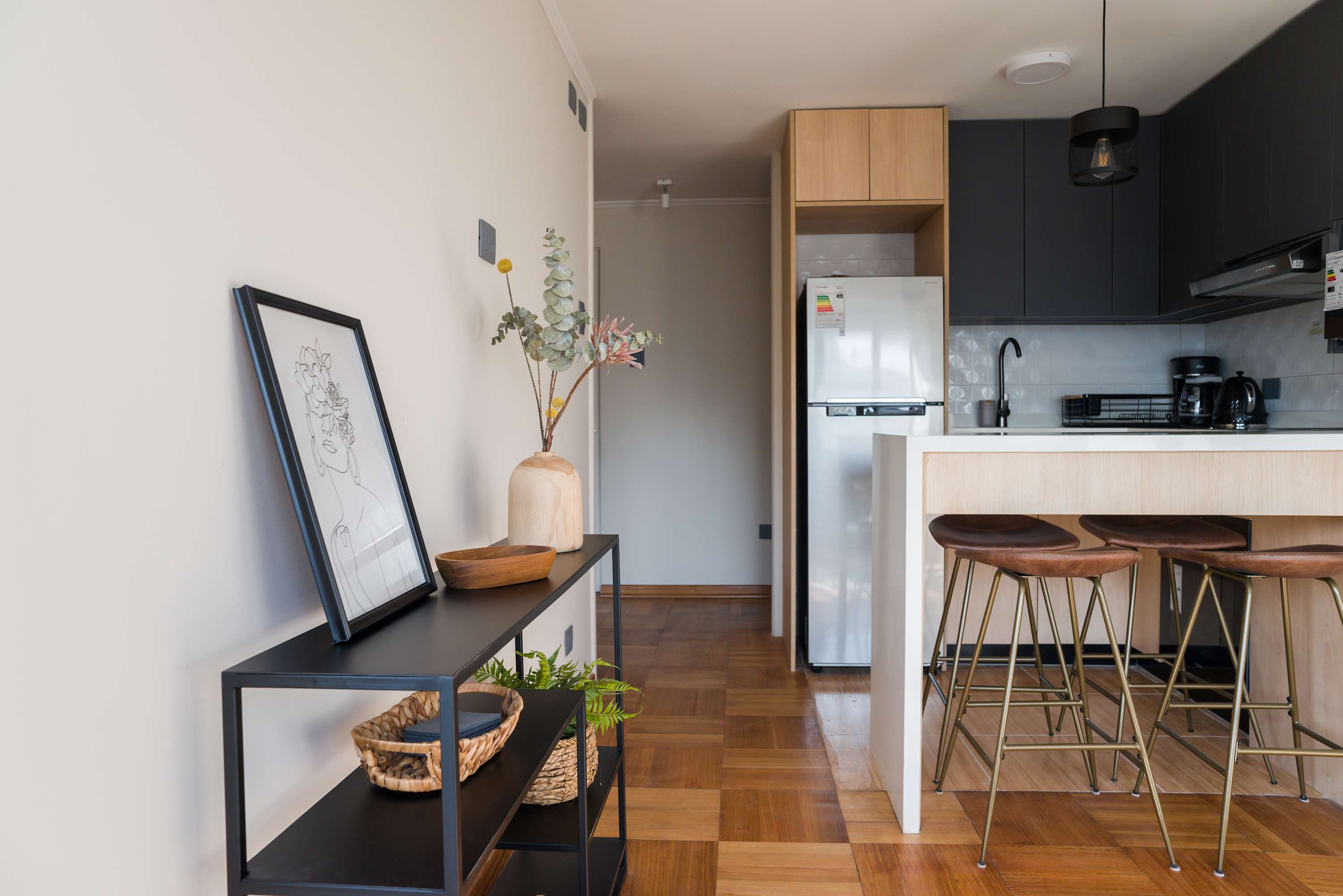Chic and modern kitchen with stylish bar seating, perfect for enjoying a cozy meal or morning coffee.