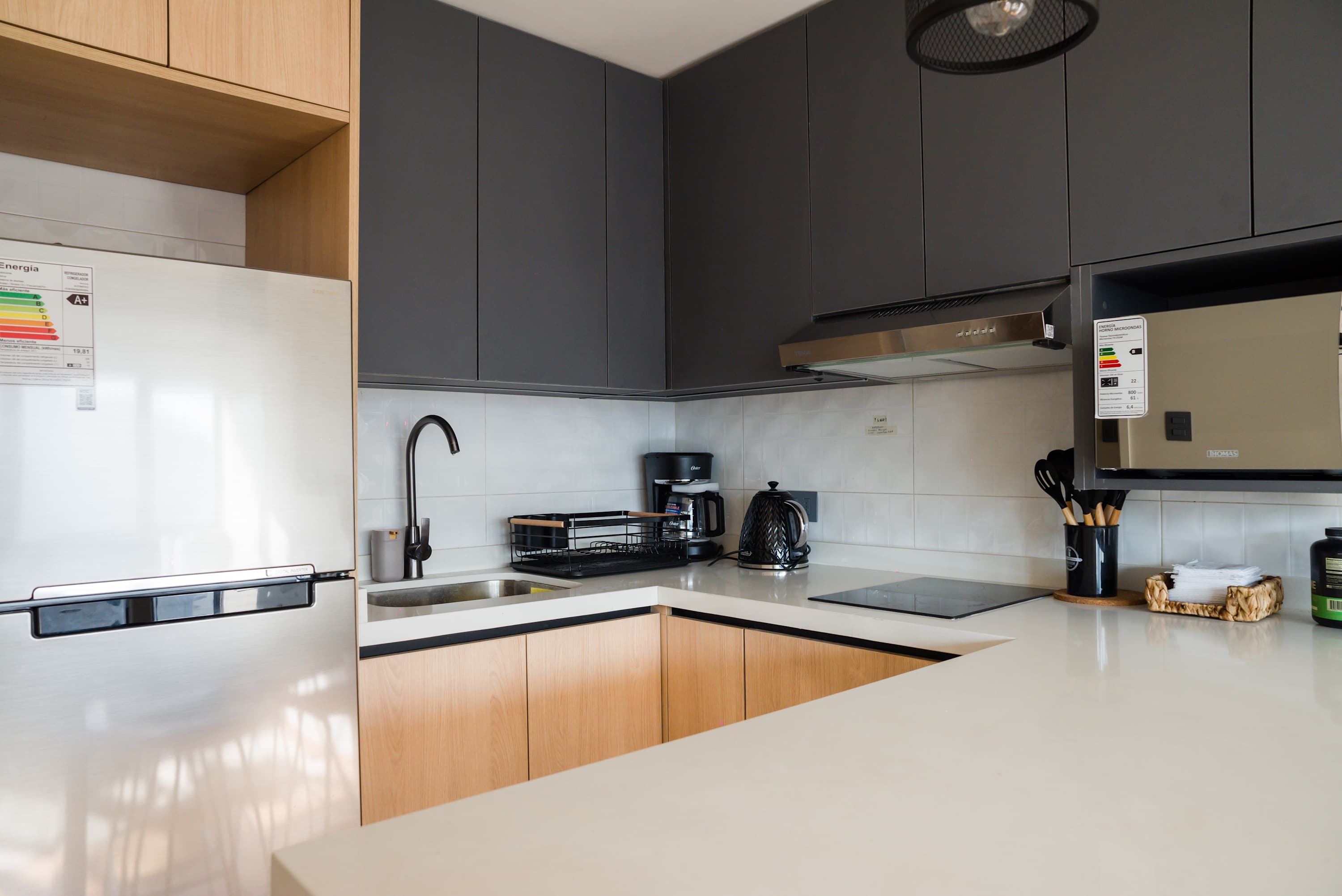 Sleek and modern kitchen with all essentials for a comfortable stay, perfect for preparing meals and enjoying your time in the apartment.