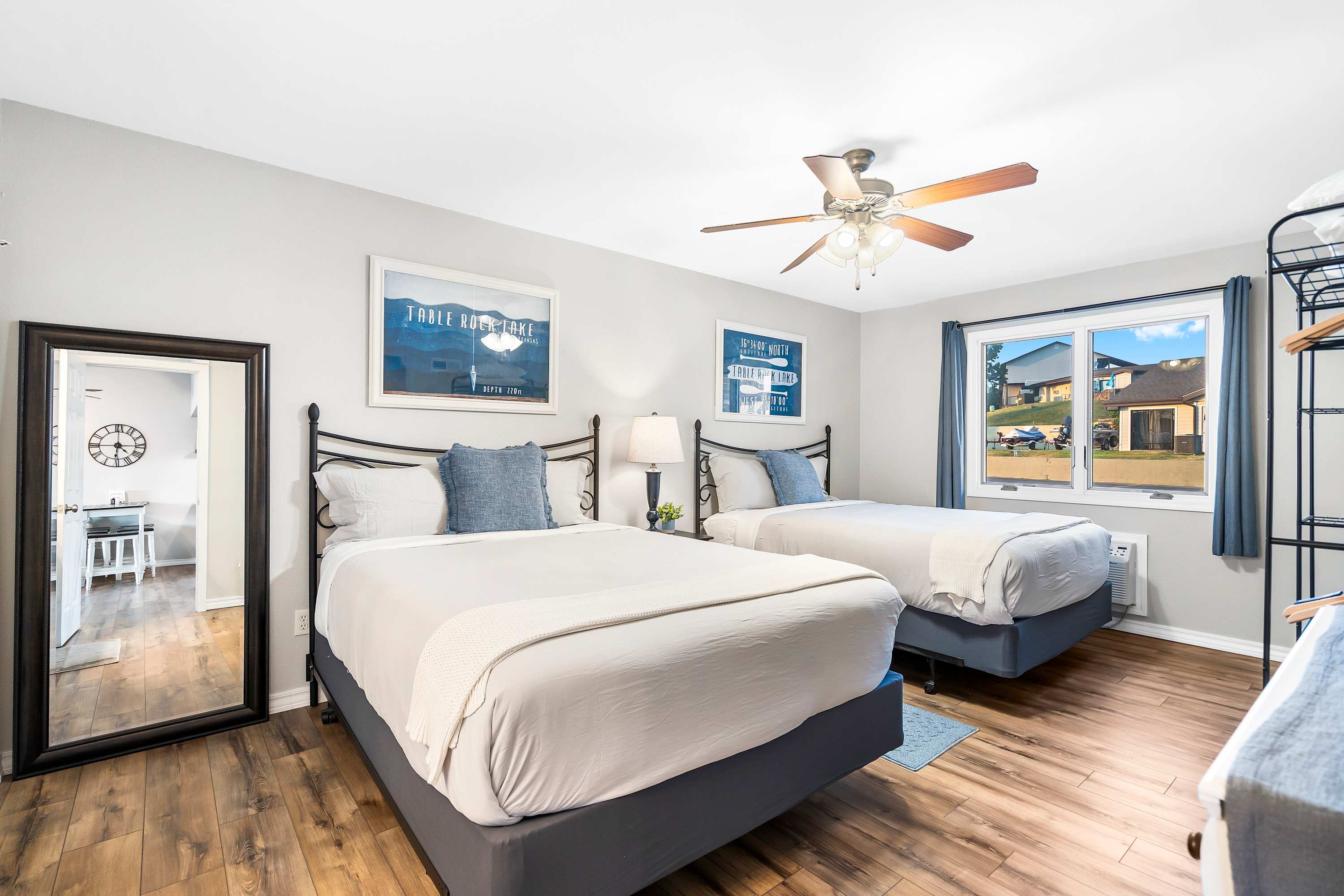 A pair of plush queen beds, TV, & ensuite await in the first of two suites​