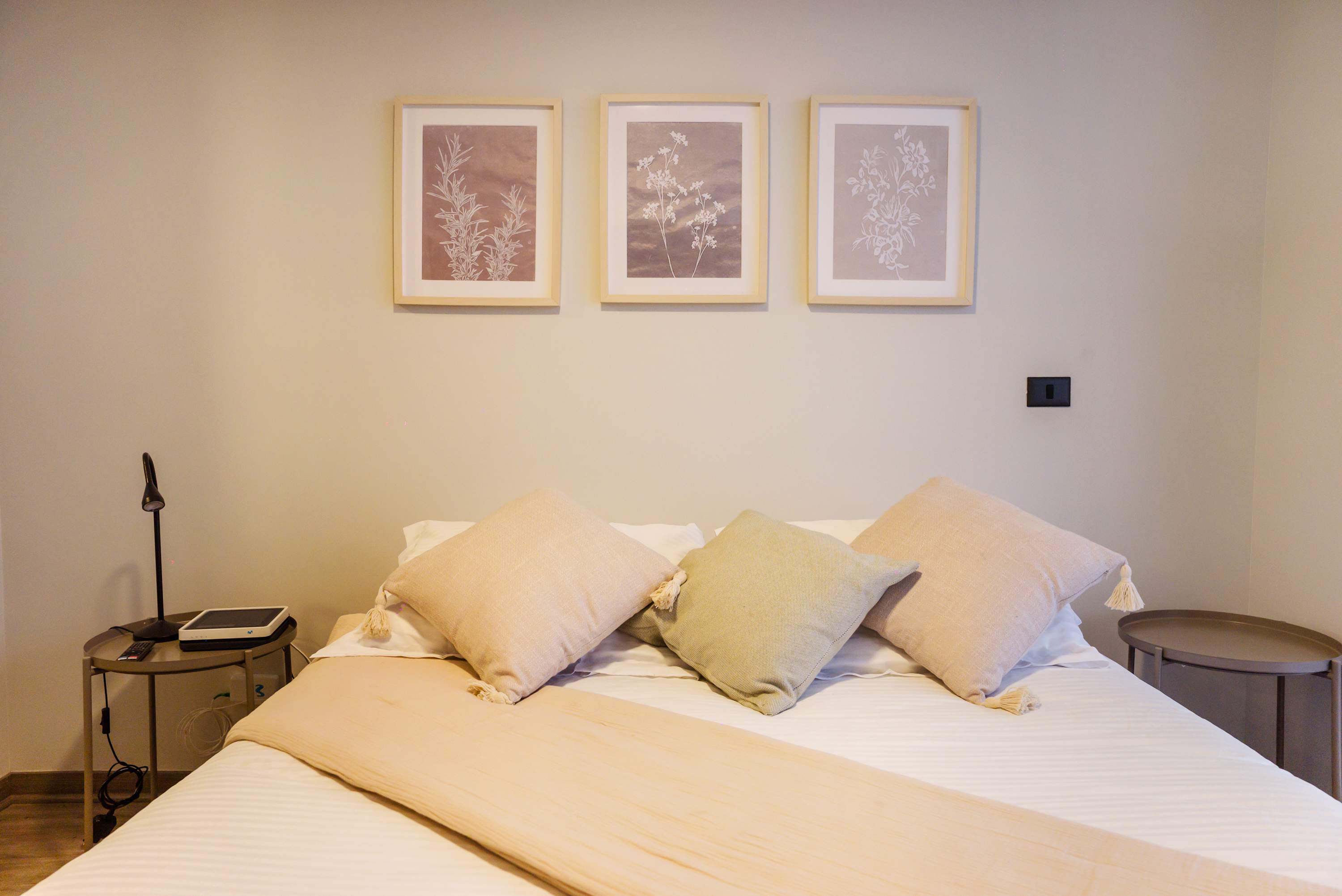 Relax in this cozy bedroom with elegant decor and soft lighting, perfect for a restful stay.