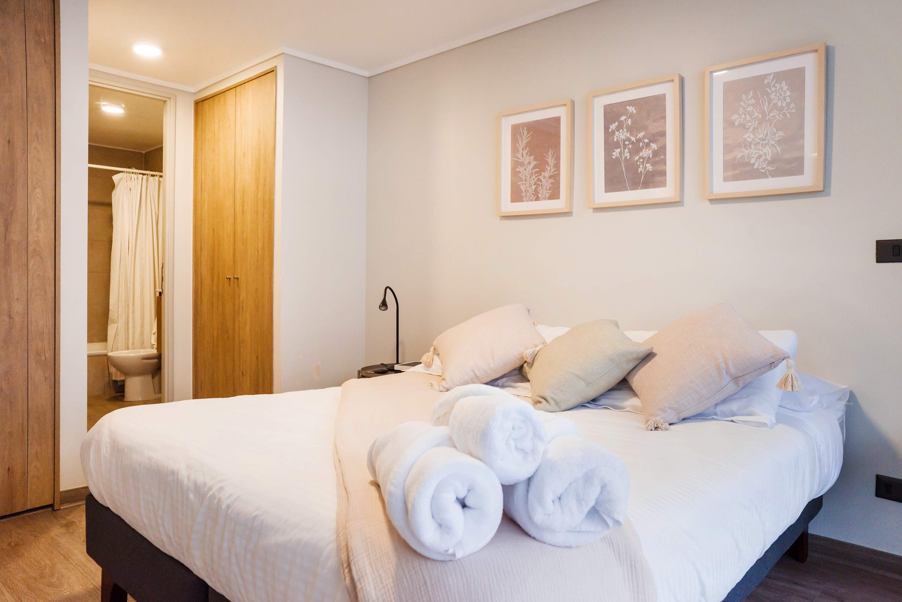 Relax in this cozy bedroom with soft linens and elegant decor, perfect for a restful stay in the heart of Chile.