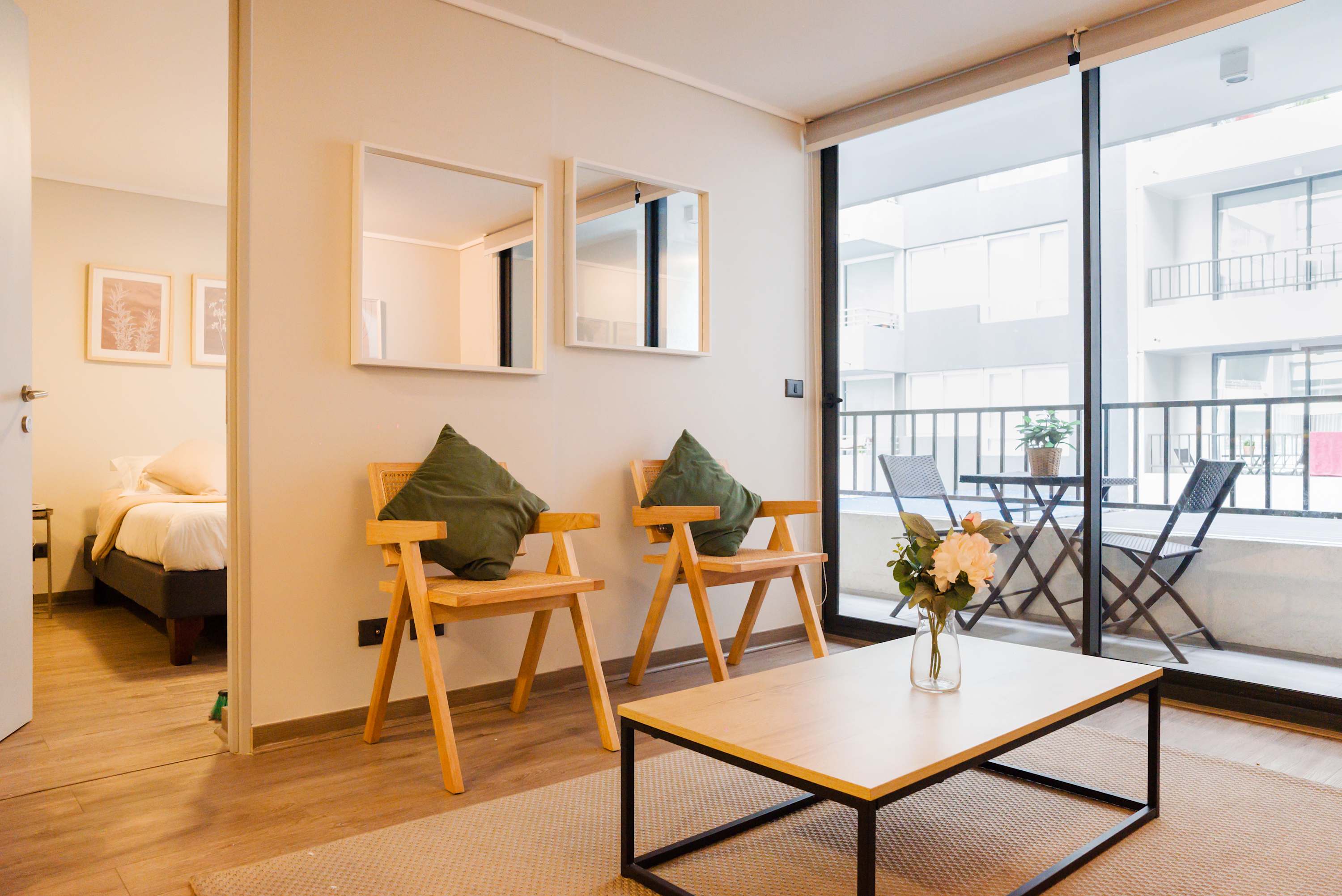 Relax in this bright and cozy living space with a charming balcony view, perfect for unwinding after a day of exploring.