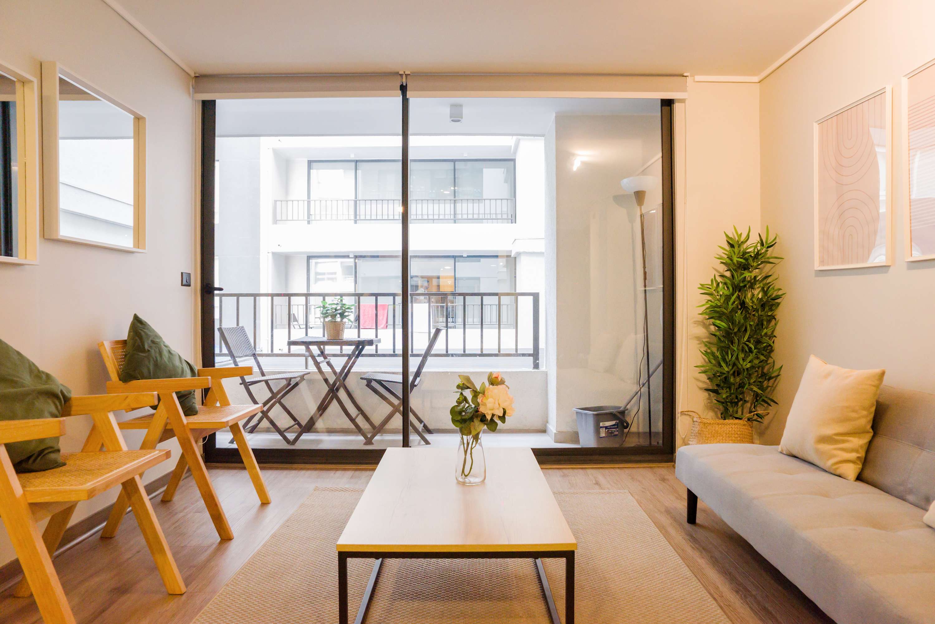 Relax in this bright and cozy living room with a charming balcony view, perfect for unwinding after a day of exploring.