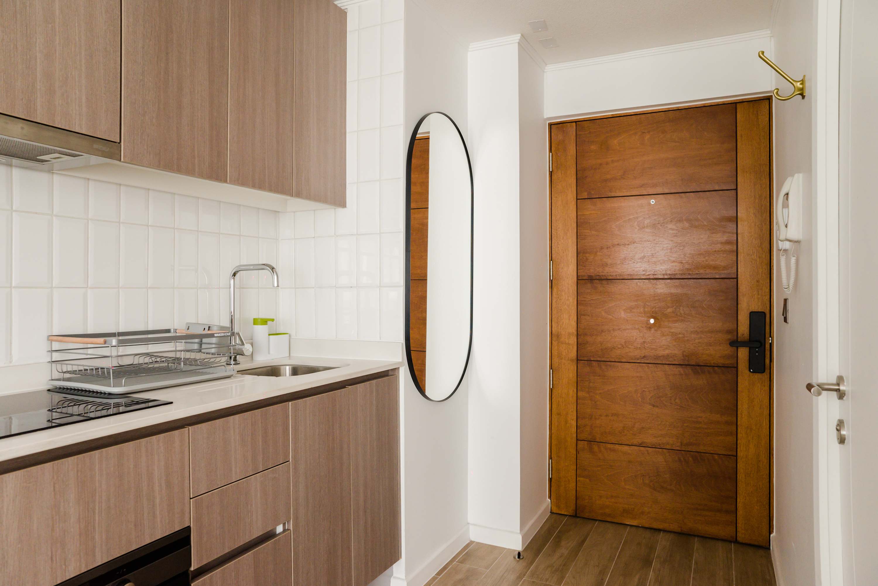 Modern kitchenette with sleek design and efficient use of space, perfect for a cozy stay.