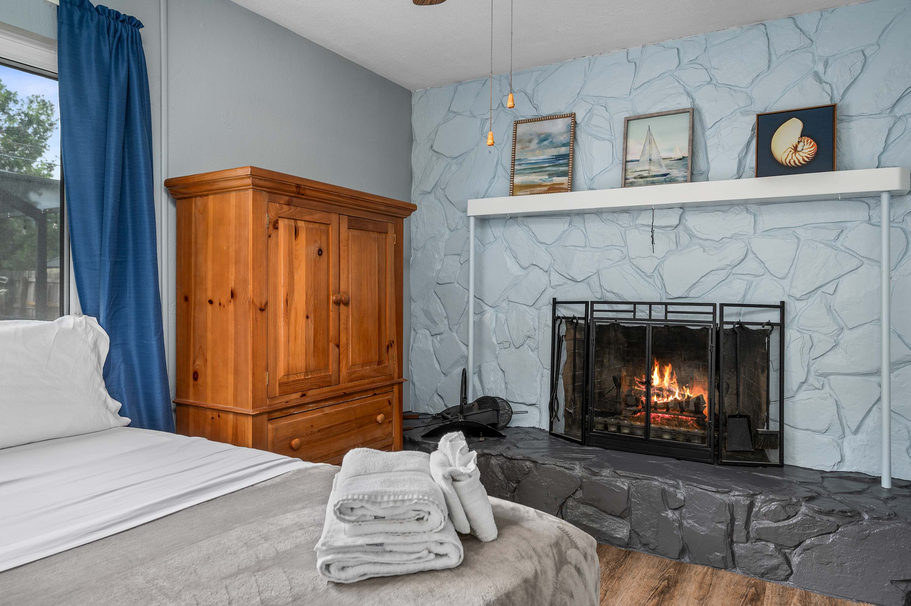 Relax and unwind in this cozy bedroom, a perfect sanctuary for your getaway. Enjoy the unique charm of the fireplace and the comfortable bed after a day of exploring.