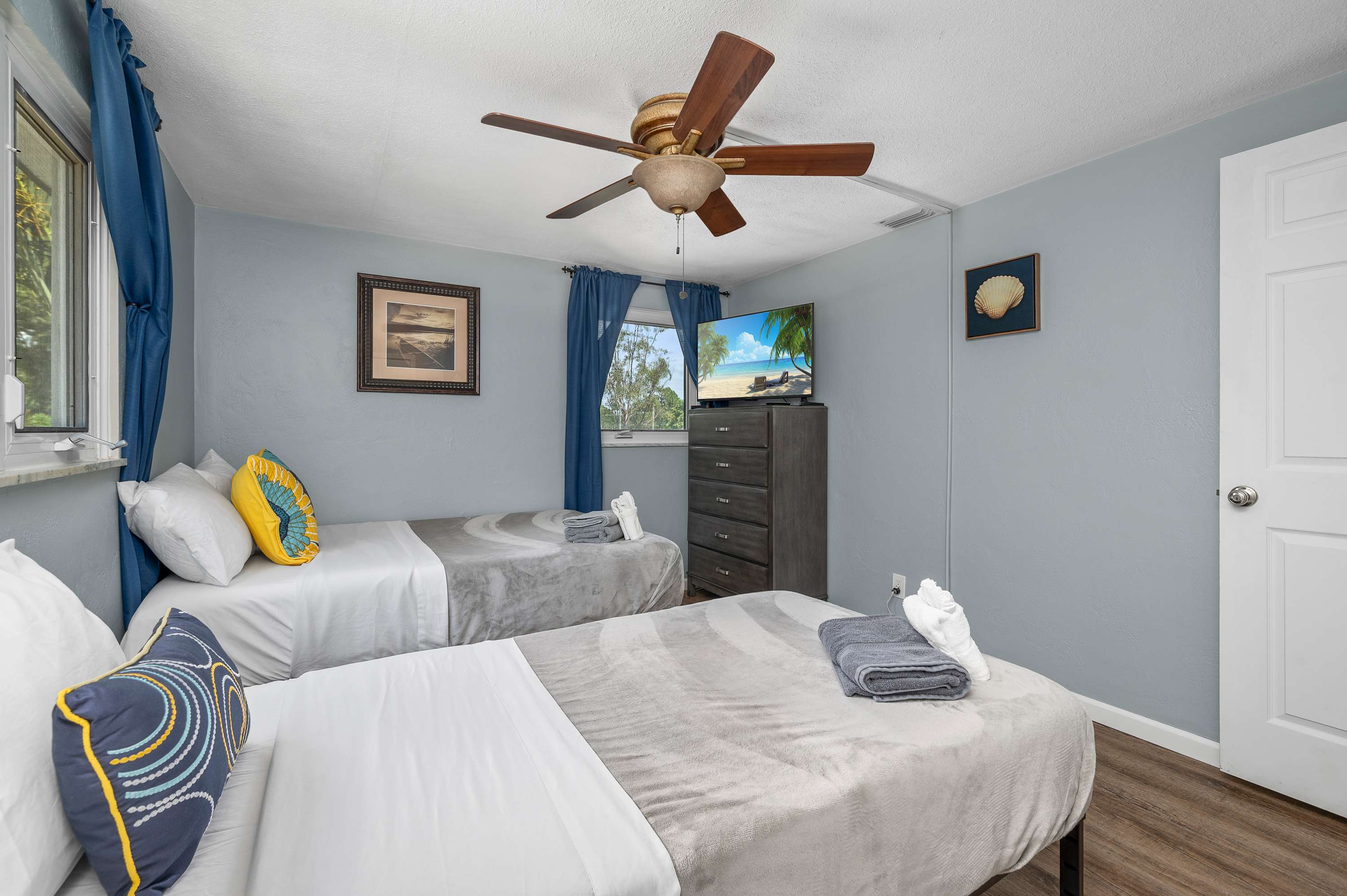 This bright and peaceful bedroom offers a great sleeping arrangement with one full and one single bed, ensuring everyone gets a good night's rest.
