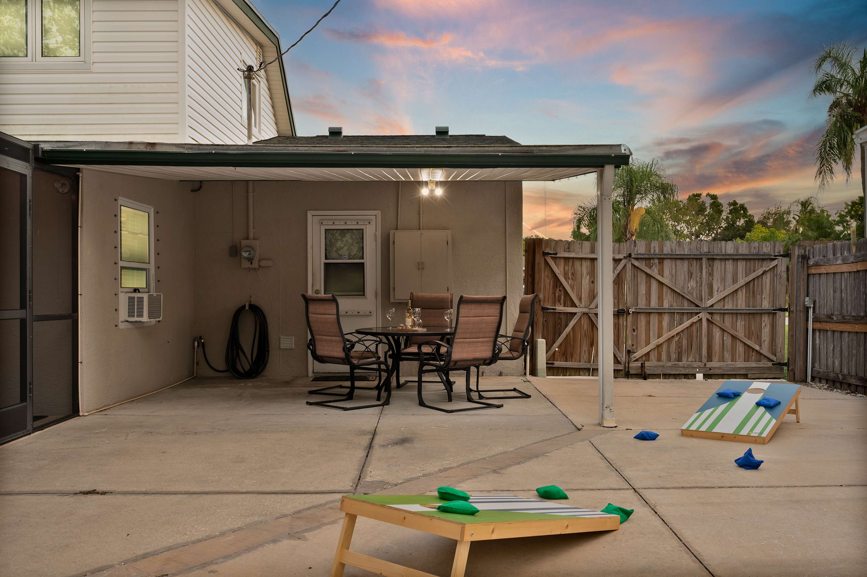 Enjoy outdoor fun in the sunshine! This spacious patio features games for friendly competition and a comfortable dining area, perfect for enjoying meals together after a day at the beach.