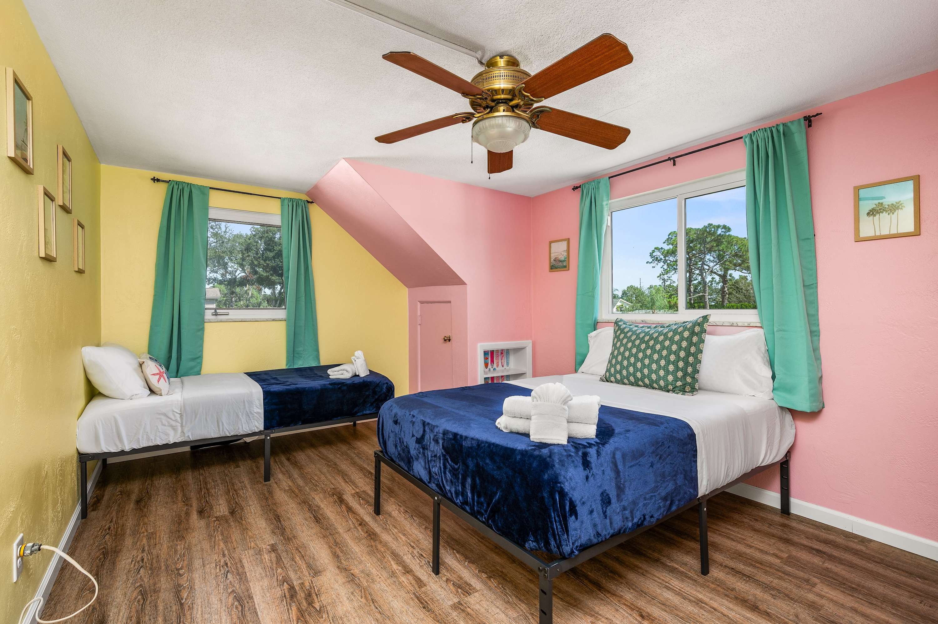 Experience a touch of whimsy in this colorful bedroom! Featuring a comfortable full-size bed and a twin bed, it's a perfect, playful space.