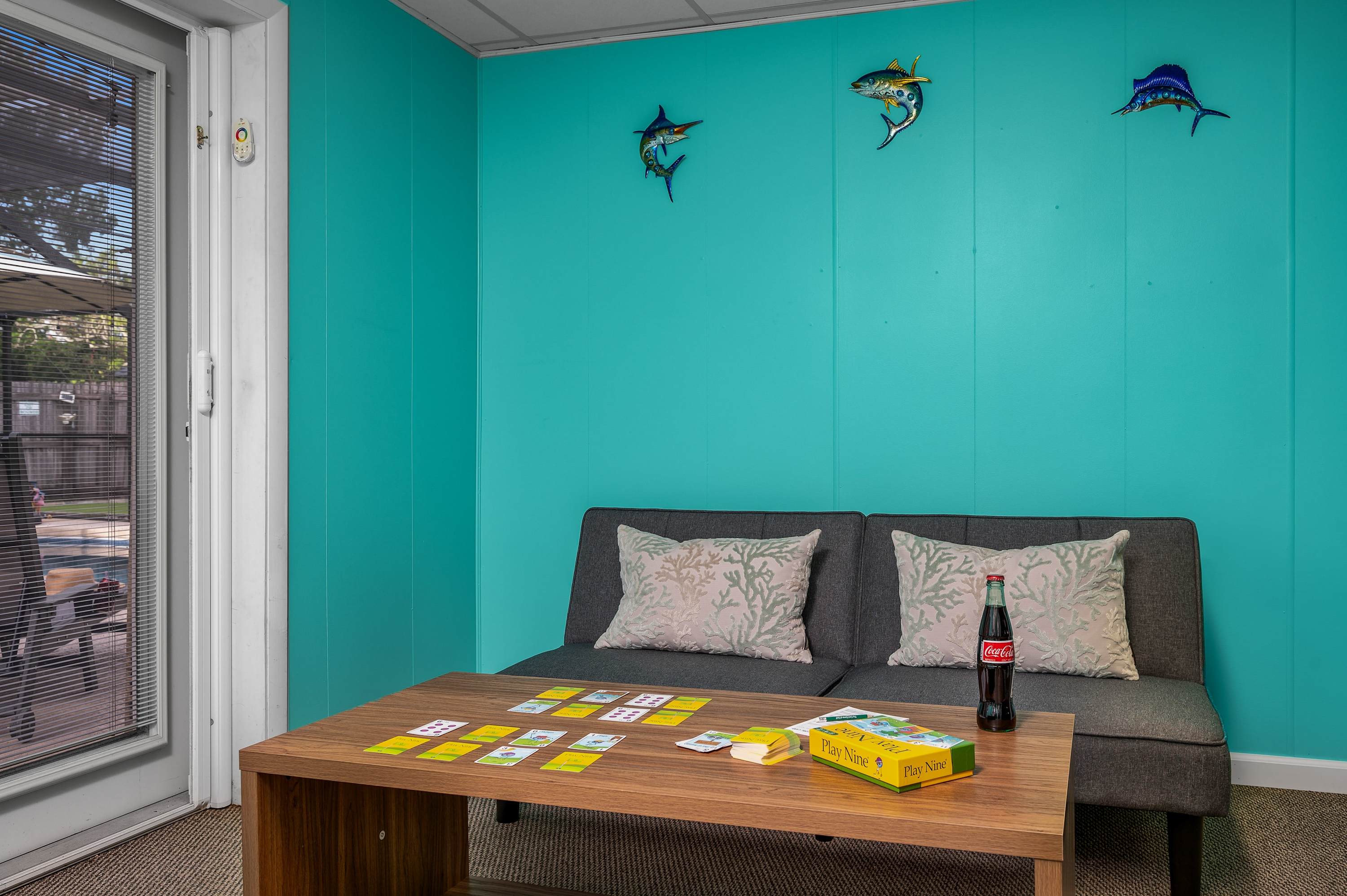 Enjoy laid-back moments in this versatile space, perfect for playing games, relaxing with a book, or stepping out to the patio.