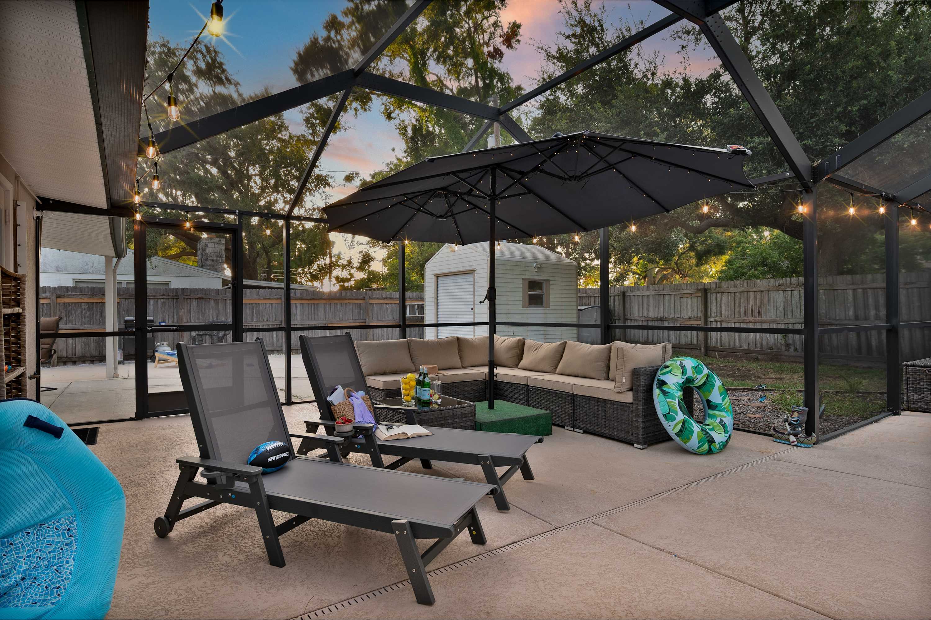 Relax and unwind in your own private, screened-in pool oasis. The comfortable lounge chairs, large umbrellas, and charming string lights create the perfect setting for a refreshing dip or a relaxing evening under the stars.