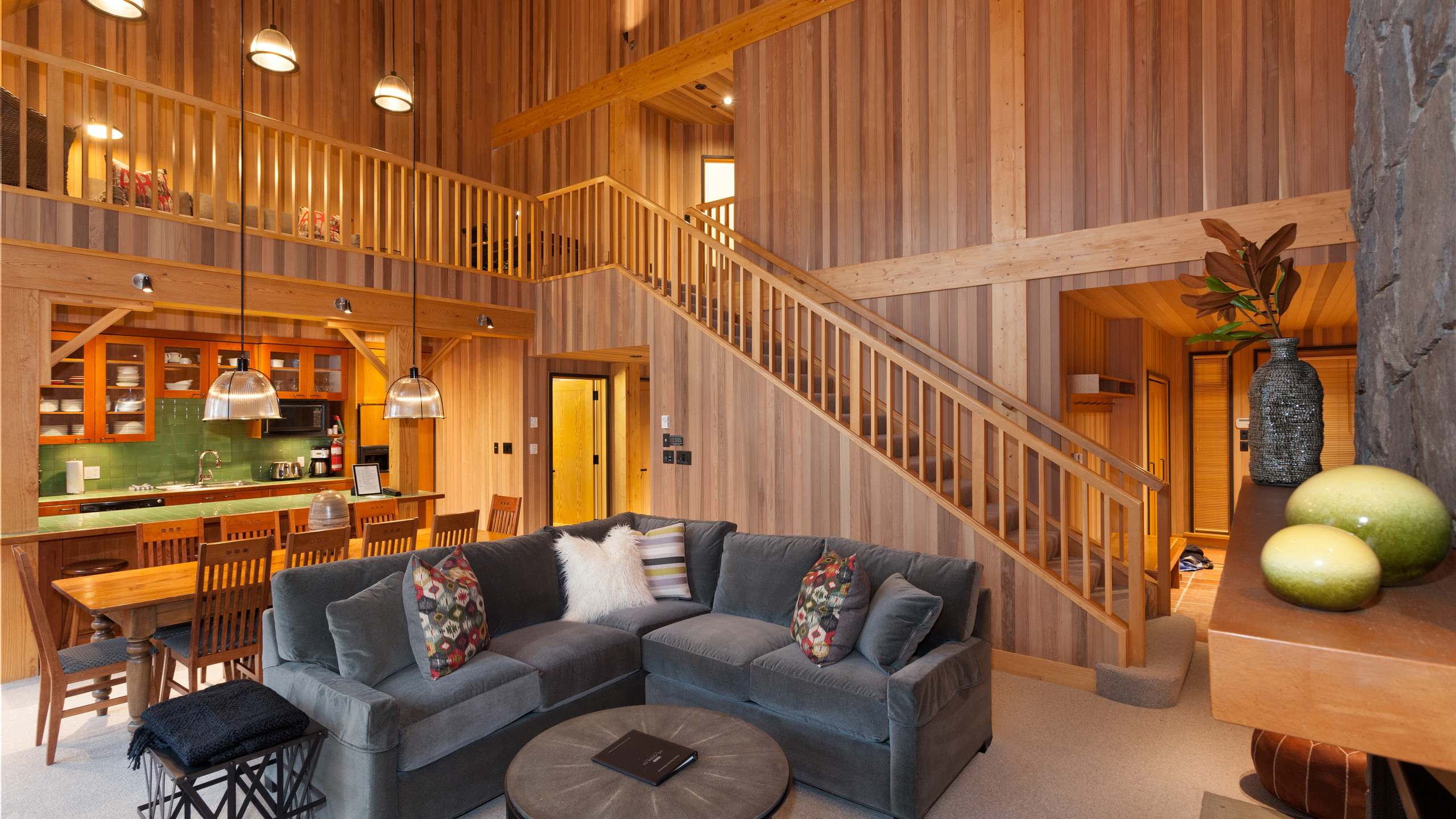 - Soaring wood-paneled ceilings and a grand stone fireplace create a warm mountain escape 
- Spacious open-concept living with plush seating for après-ski relaxation 
- Gather for cozy nights by the fire in this Whistler mountain chalet 
