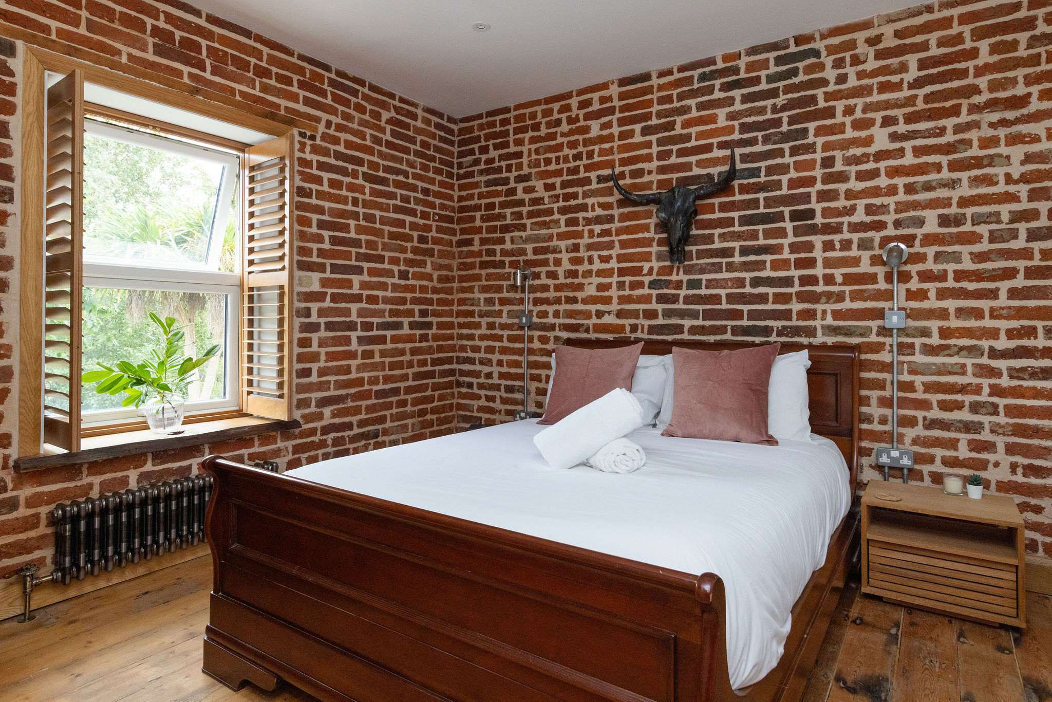 Bedroom 2- Brick walls are a running theme throughout the property!