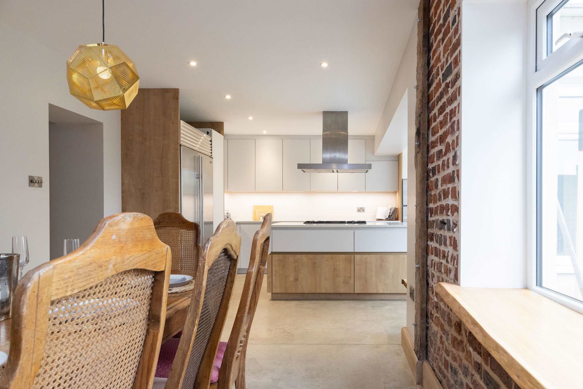 High-back chairs at the dining table create an atmosphere of understated character.