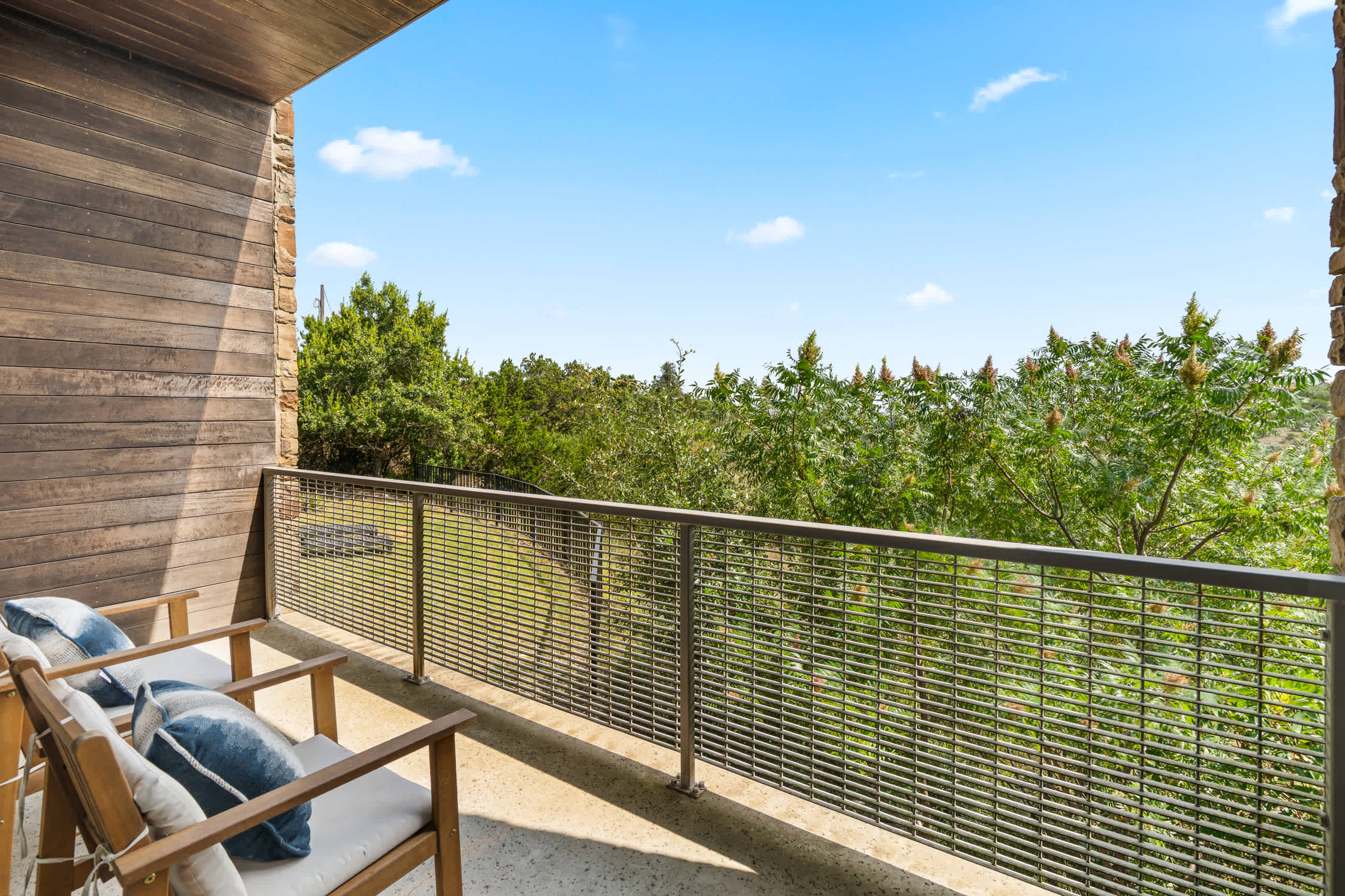 Outdoor balcony patio with hot tub and sun loungers
