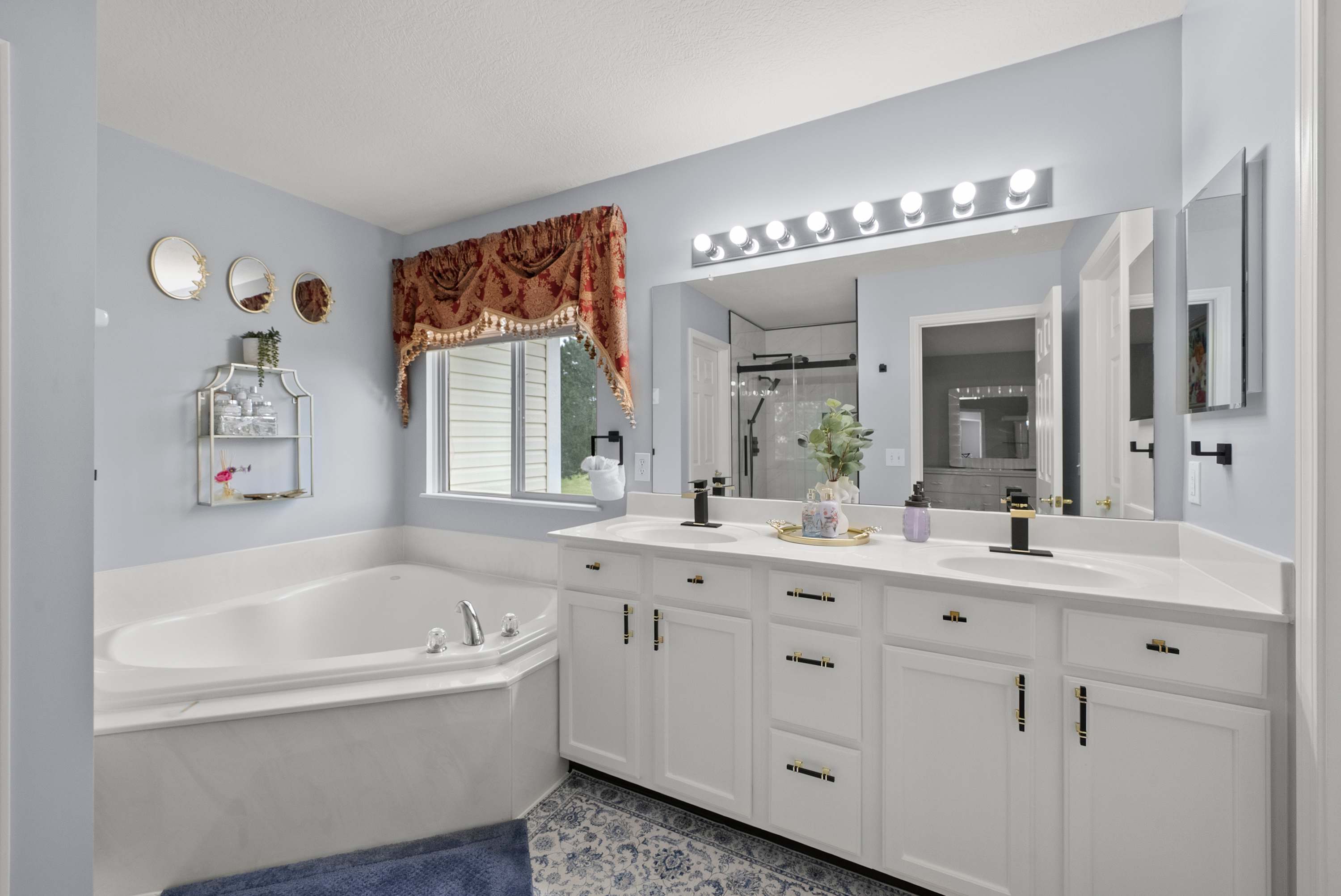 The king ensuite features a double vanity, shower, & soaking tub​