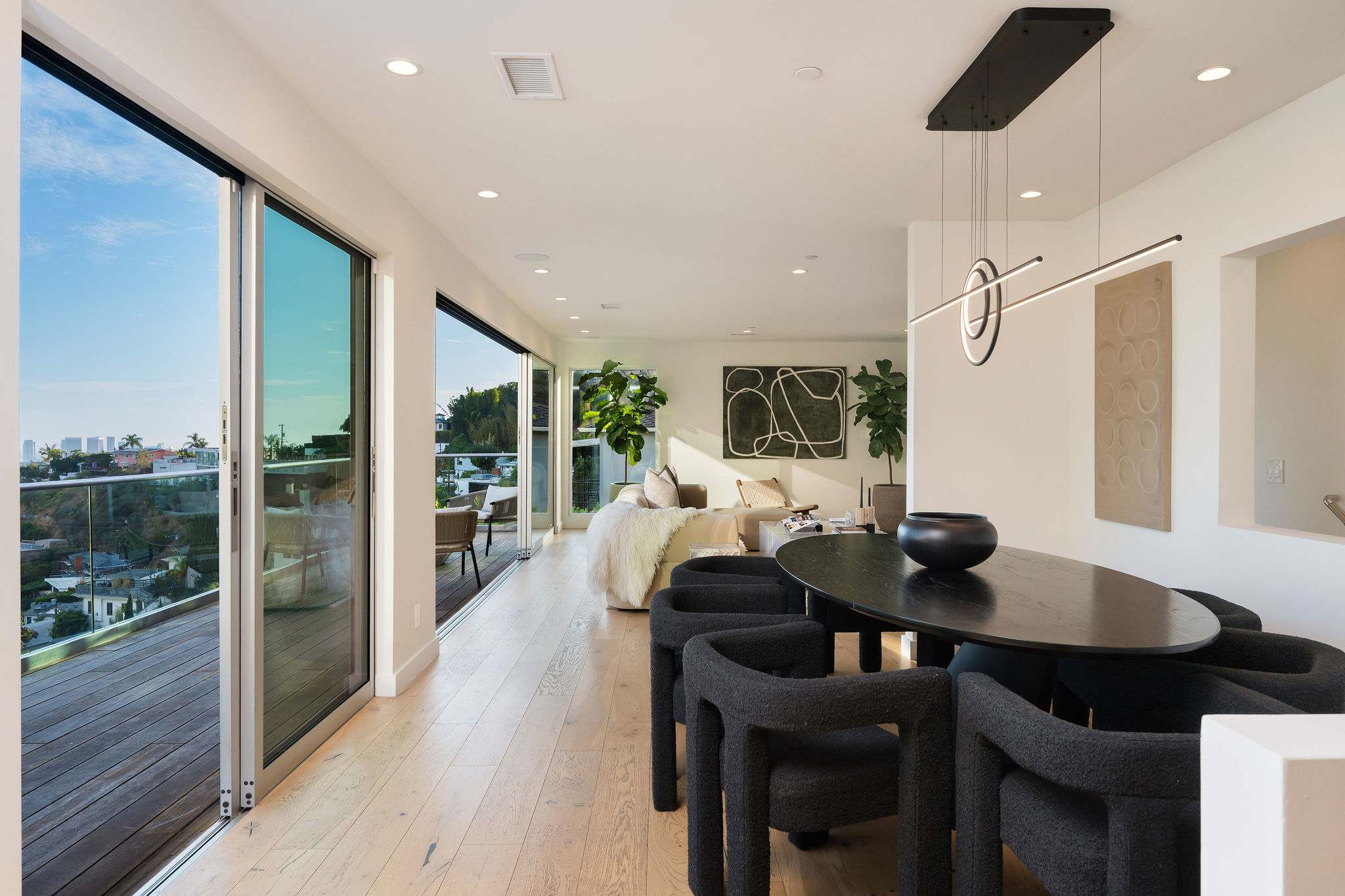 Grand open-concept living room with floor-to-ceiling glass walls.