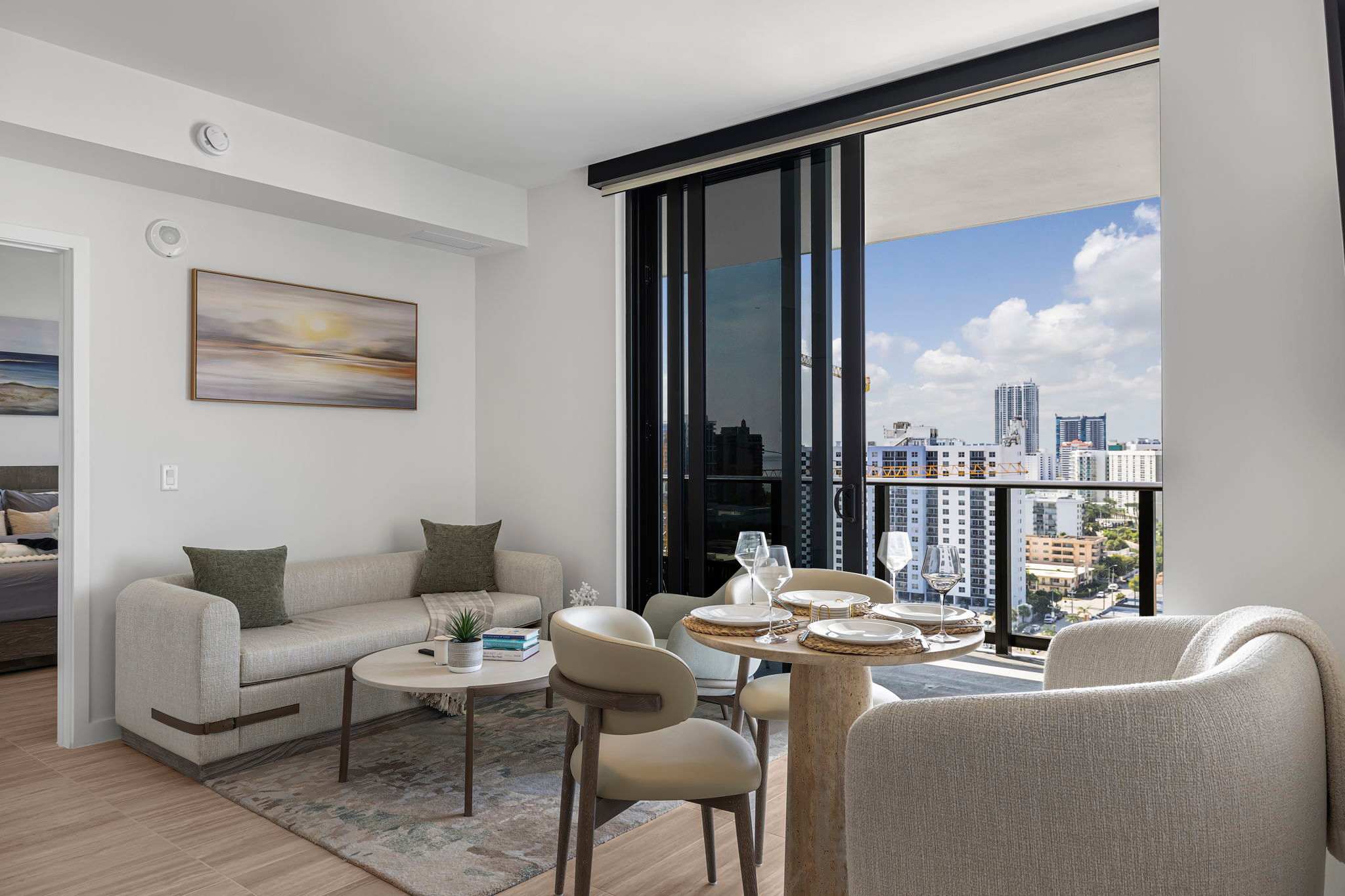 Relax in a stylish living room with stunning city views, perfect for unwinding or dining with friends.