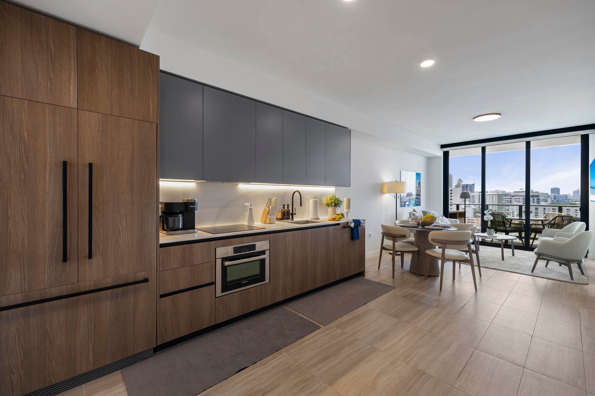 Experience urban living with a modern kitchen and stunning city views from your dining area.