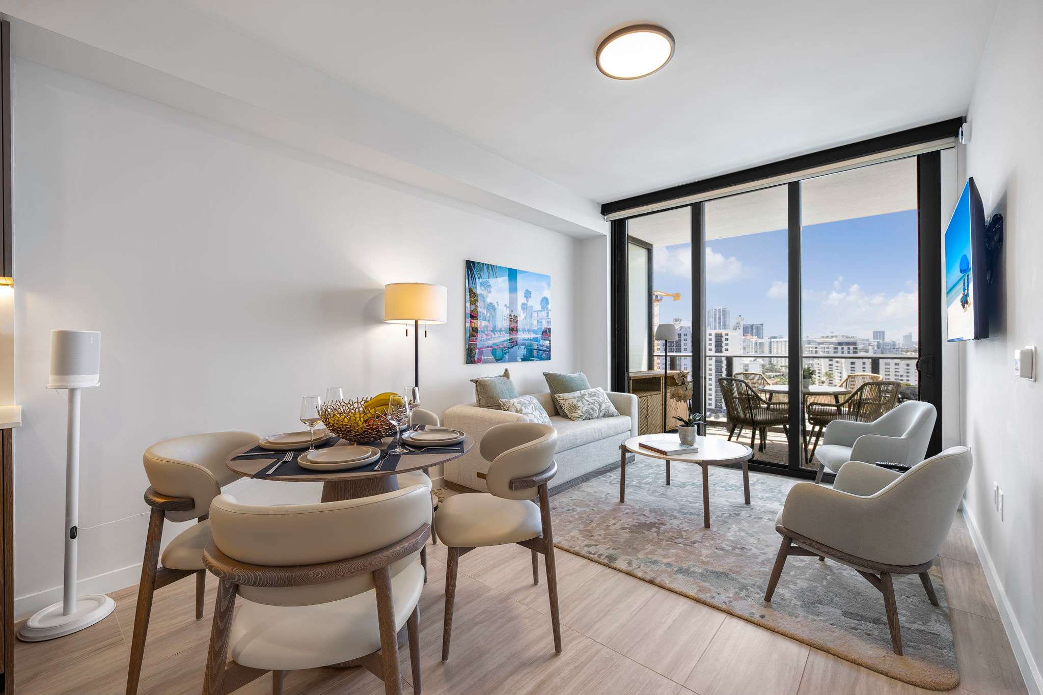 Bright and modern living space with stunning city views, perfect for relaxation and dining.