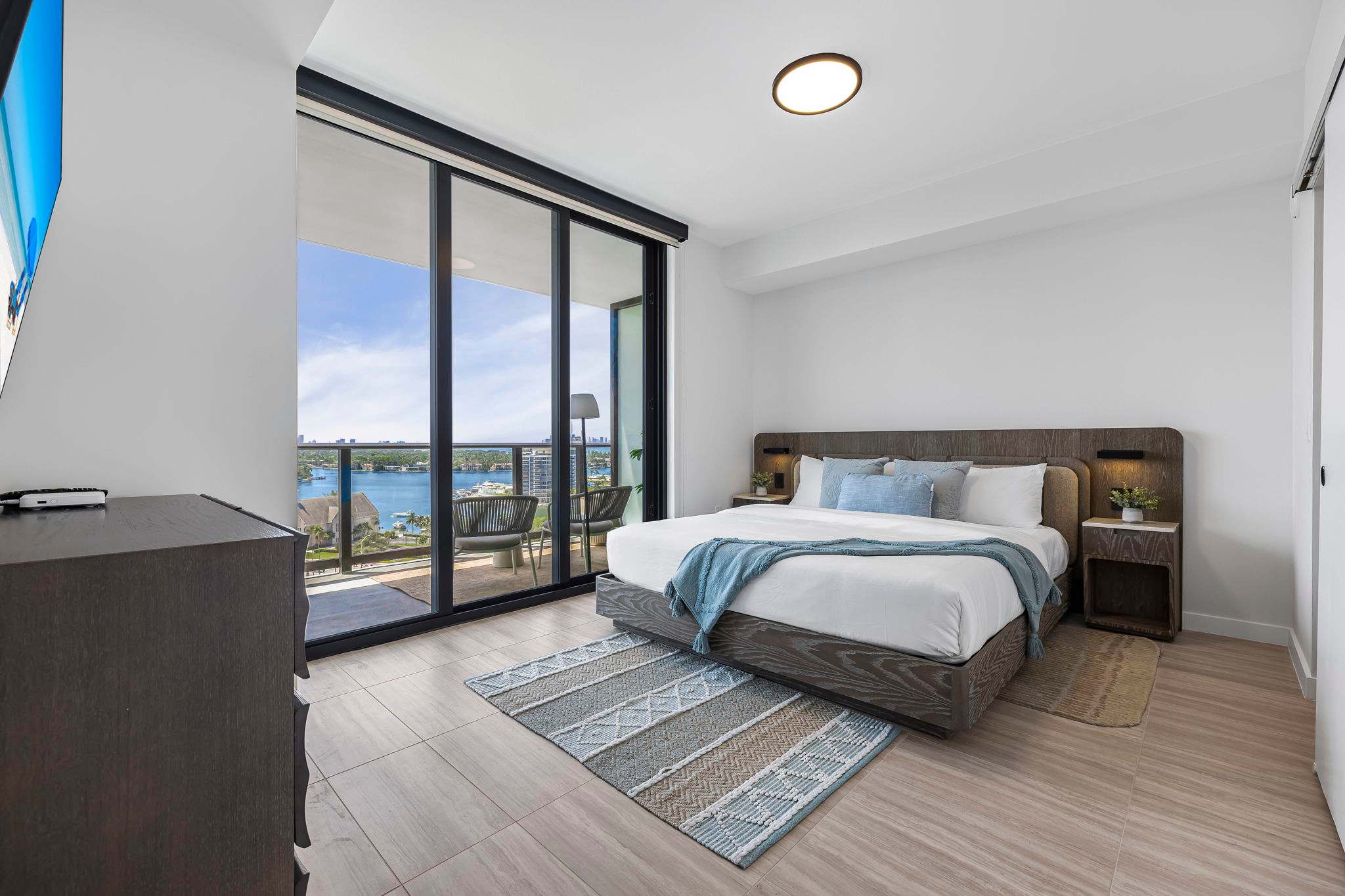 Relax in this serene bedroom with breathtaking water views and modern comforts. Perfect for a peaceful getaway.