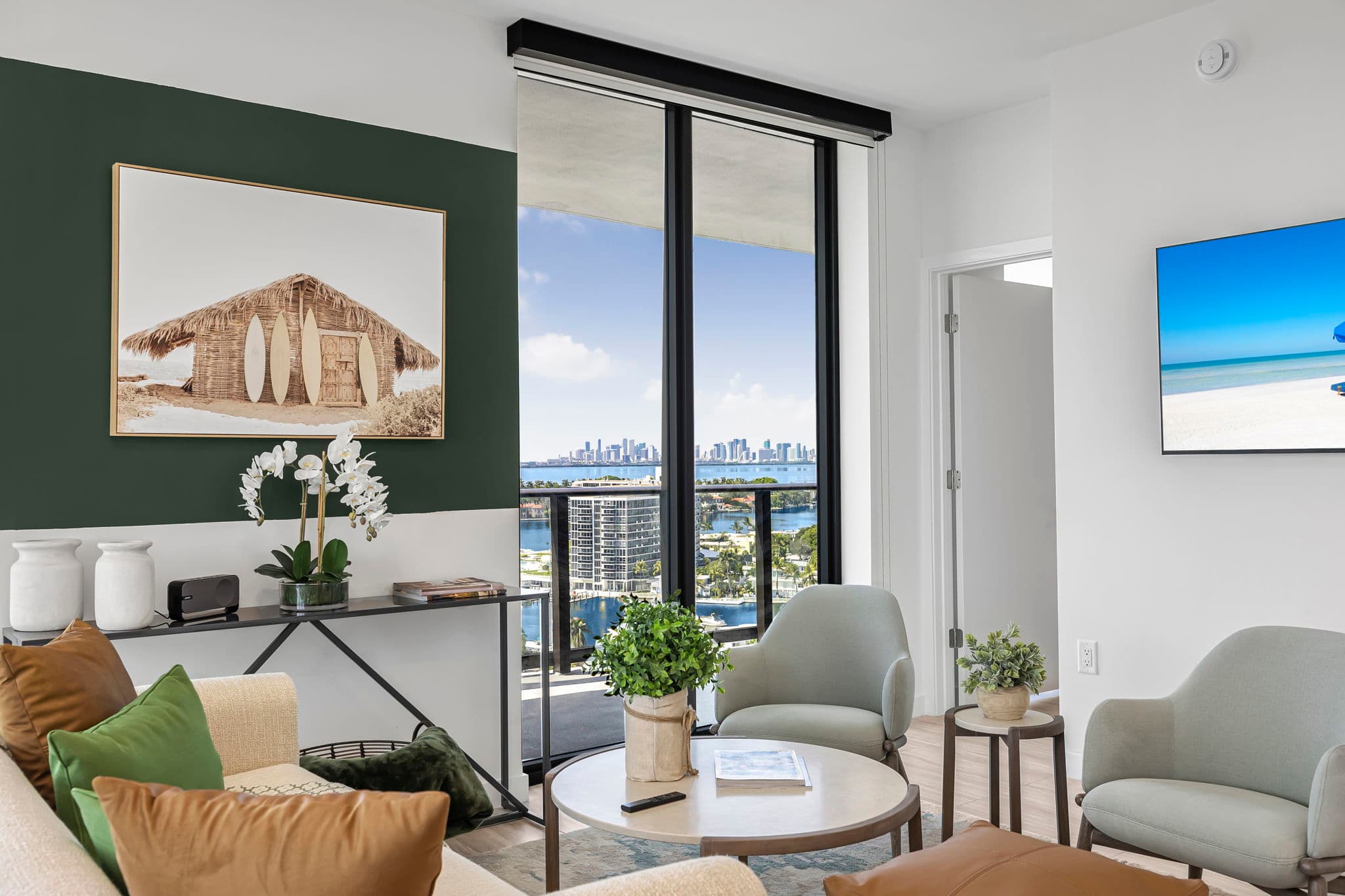 Relax in a stylish living room with stunning city and water views, perfect for unwinding after a day of exploring.