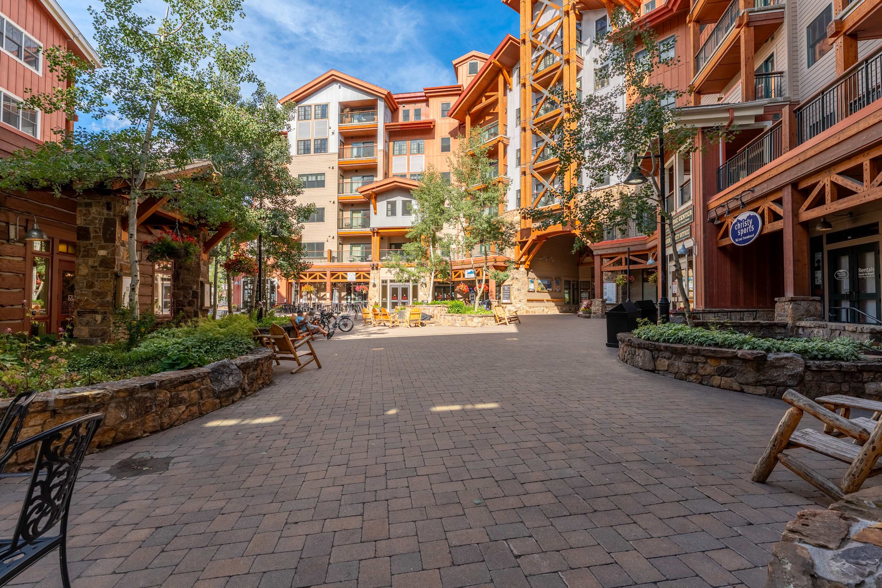 Colorful historic buildings on a main street in a Colorado mountain town with mountains behind