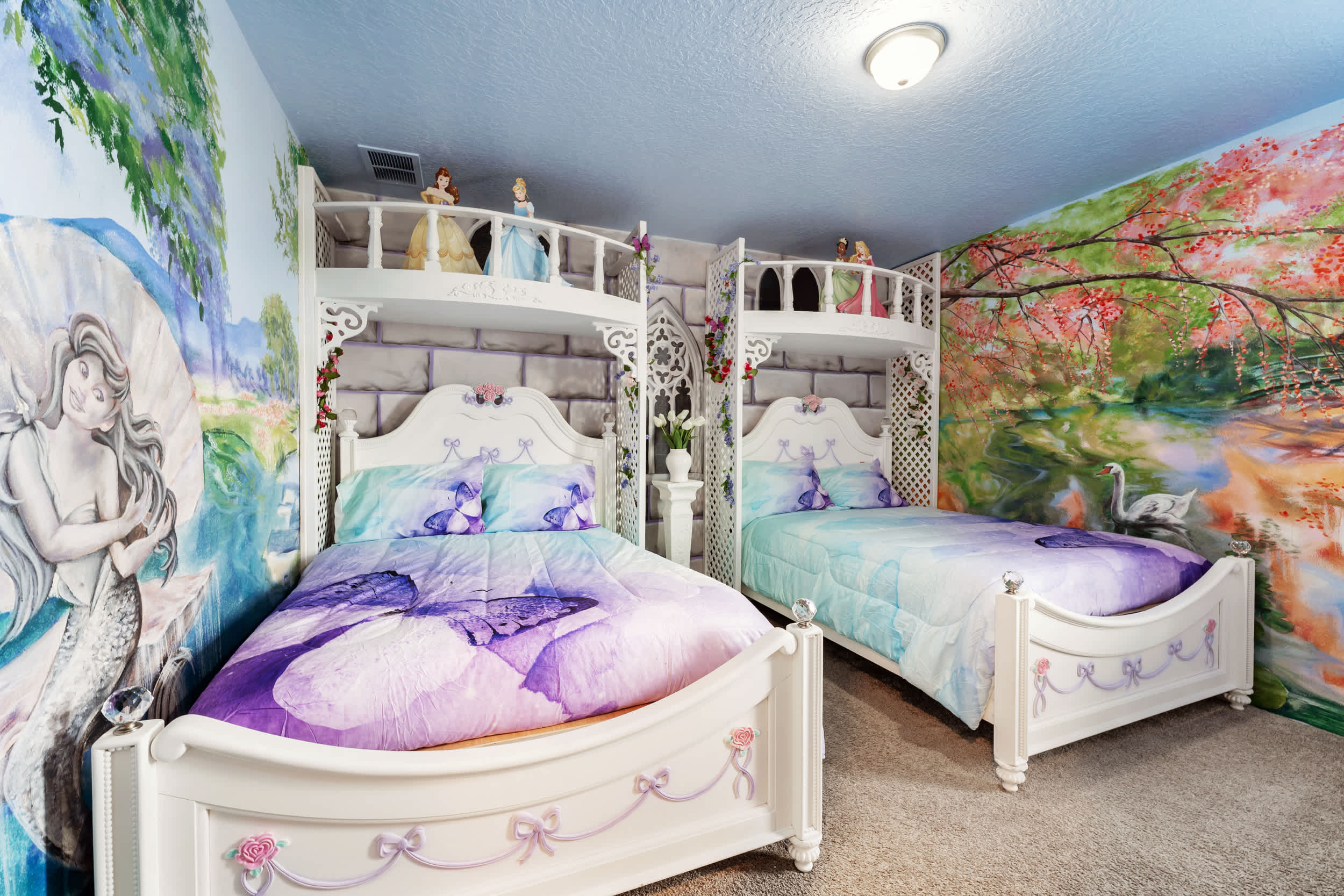 Step into a magical realm with fairy-tale murals and whimsical decor in this enchanting themed bedroom.