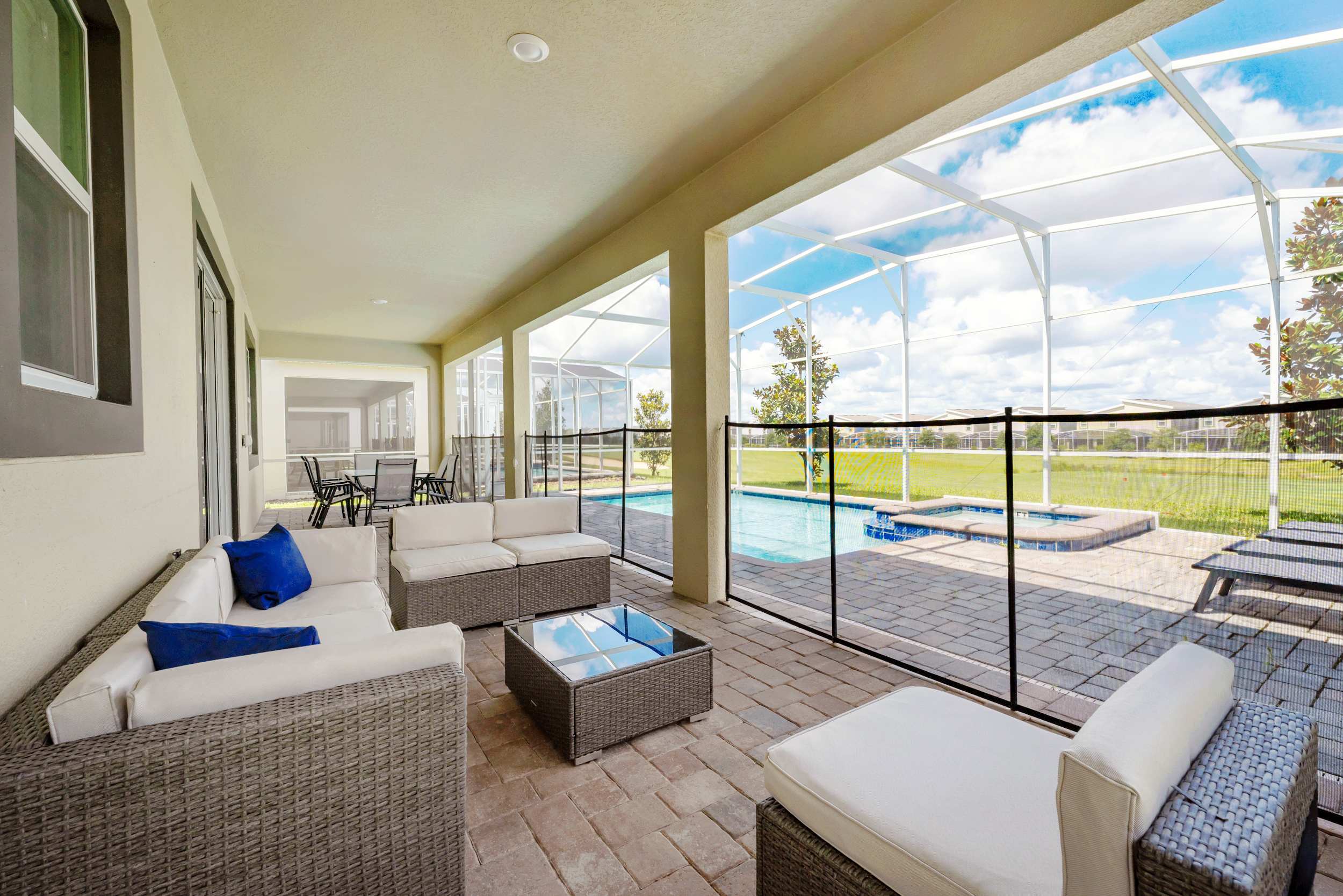 Enjoy the serene patio with plush seating and pool views, perfect for relaxation and entertaining.