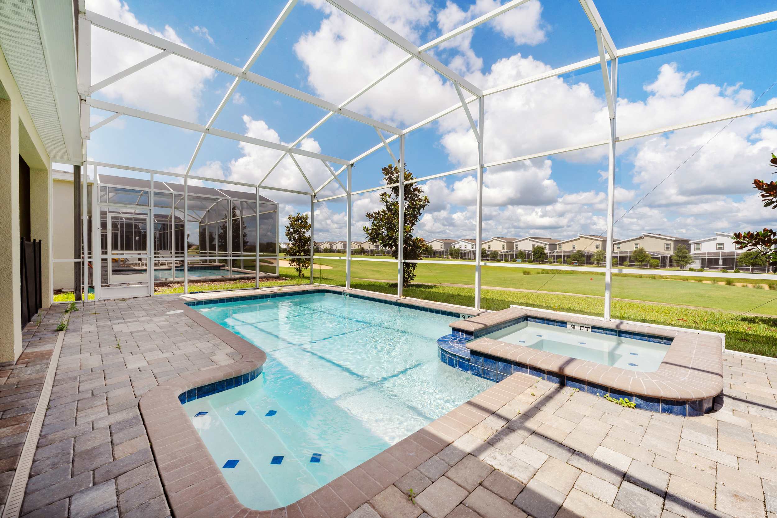 Relax in your private screened pool and hot tub with serene views, perfect for unwinding under the sun.
