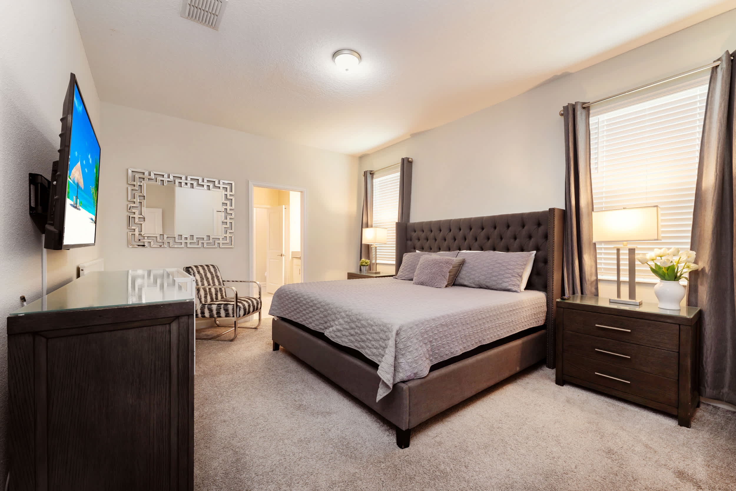 Elegant bedroom with a plush king-size bed, stylish decor, and cozy seating, perfect for unwinding after a day of adventure.