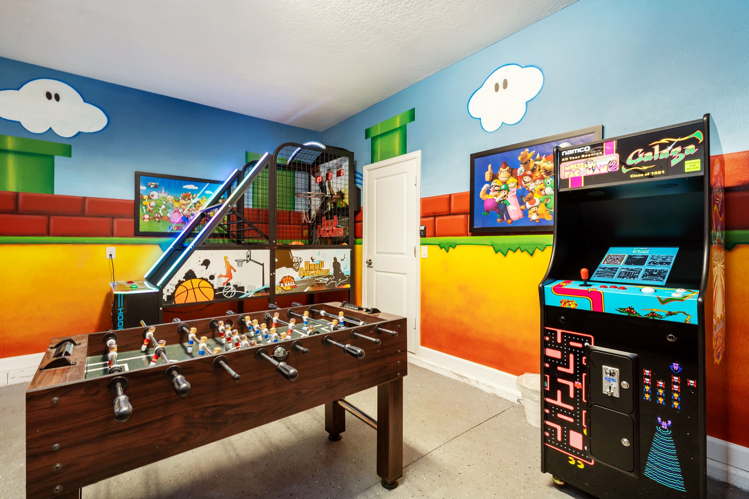 Dive into nostalgia in this vibrant game room with arcade classics and foosball, perfect for family fun and entertainment.
