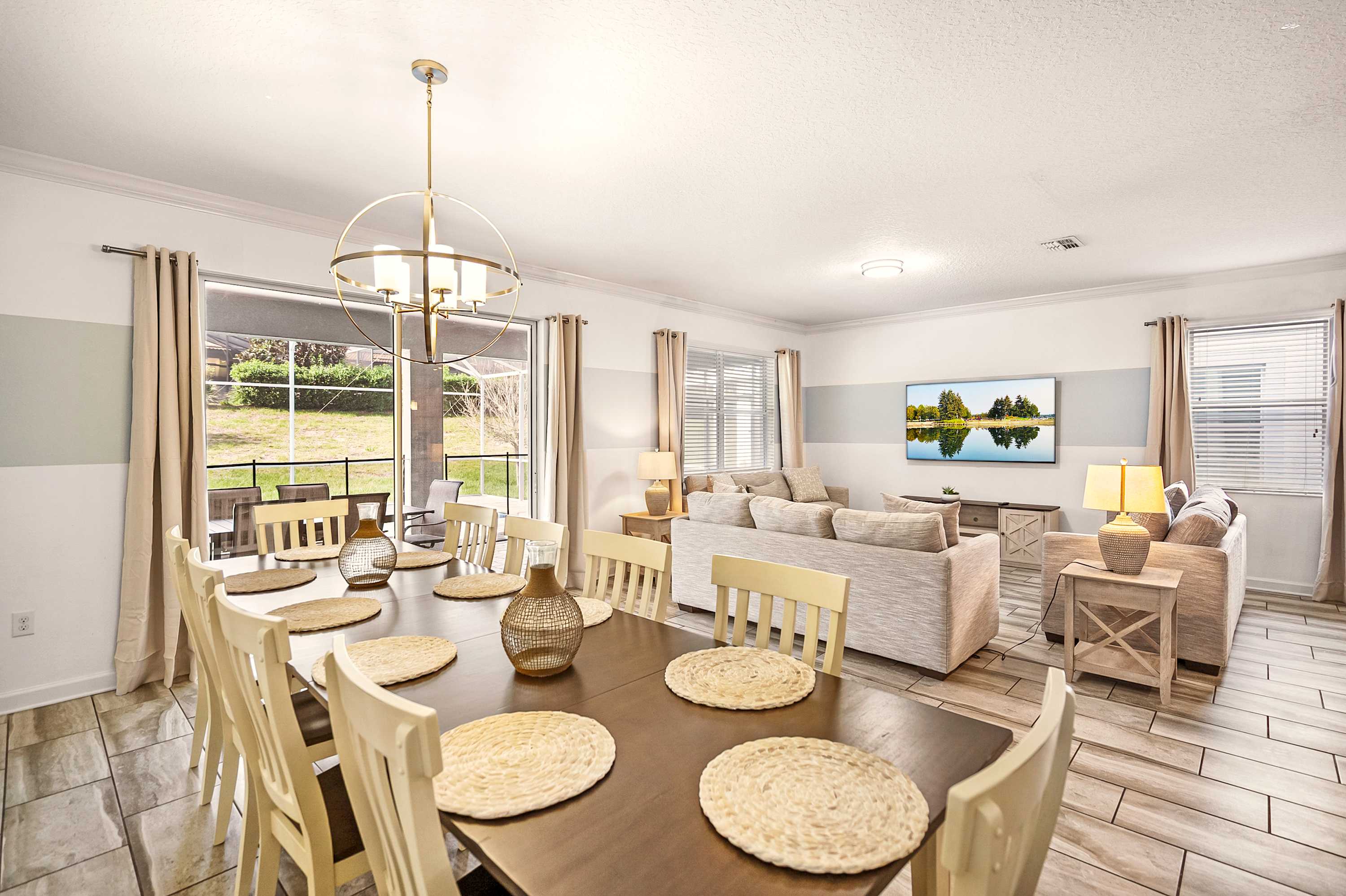 Elegant dining and living area with ample seating, perfect for gatherings. Enjoy natural light and modern decor in this inviting space.