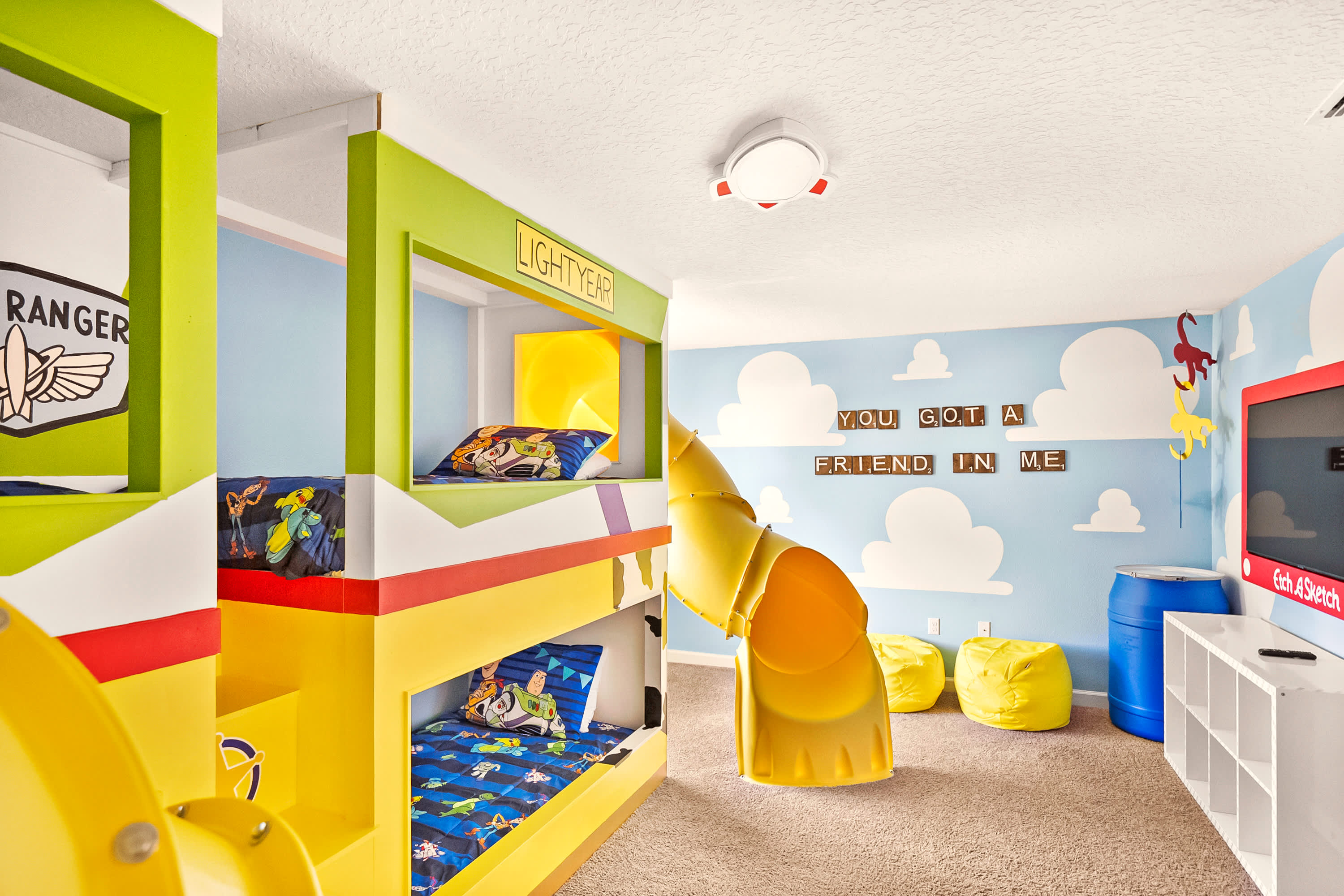 Experience the magic in this vibrant themed room with bunk beds, slide, and playful decor, perfect for family fun and adventure.