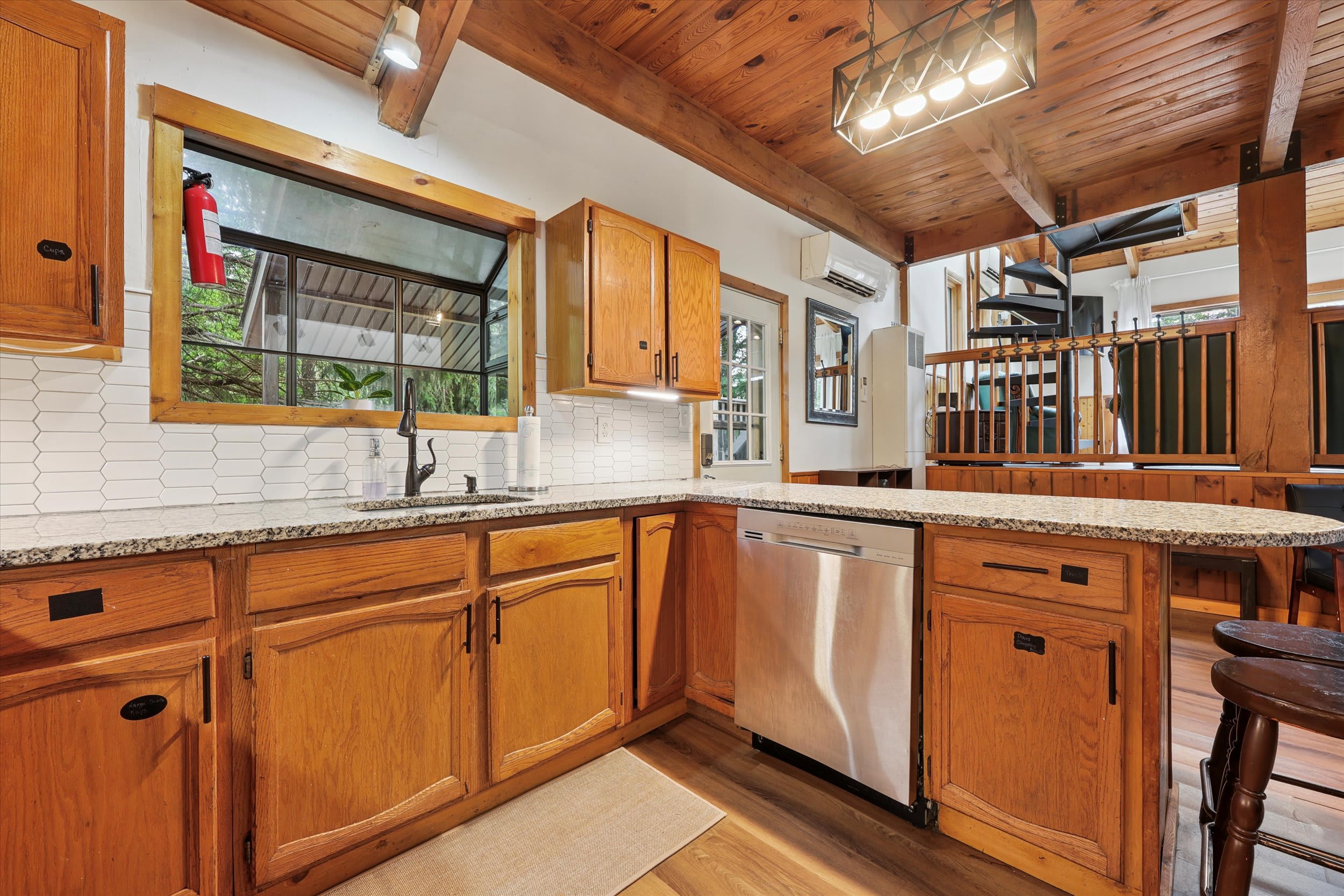 The warm wood kitchen features plenty of cabinet space and all the essentials for home cooking.