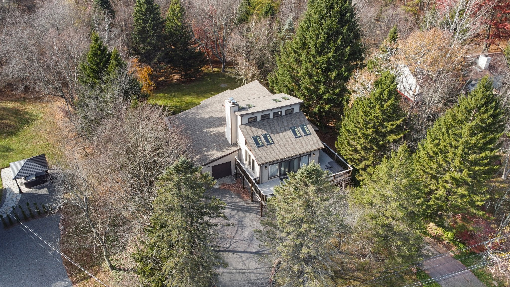 An aerial view shows the home nestled among the beautiful fall foliage of the Poconos.