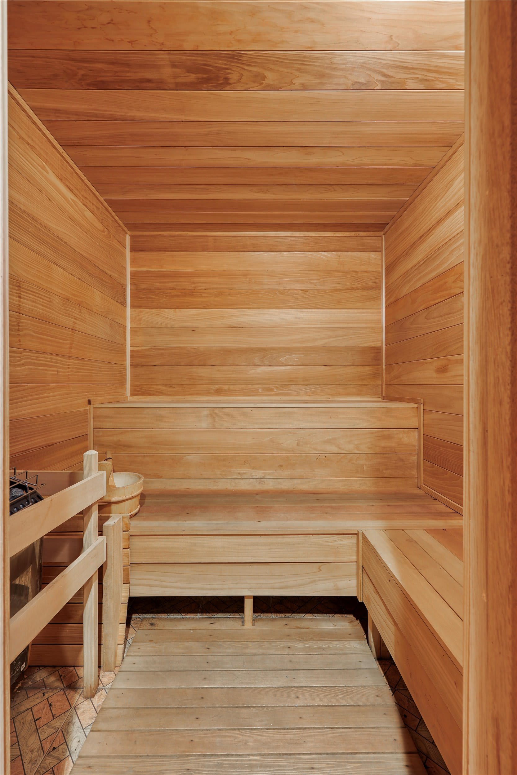 A full bathroom with walk-in shower, skylight, and wood-finished vanity for your comfort.