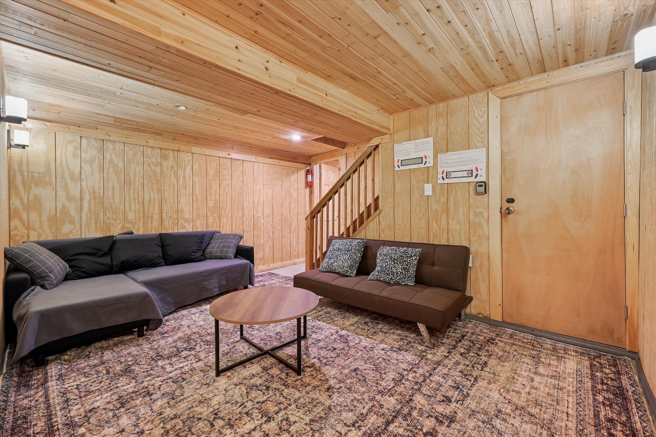 The lower level lounge offers extra seating with a sectional sofa and leather futon for winding down.