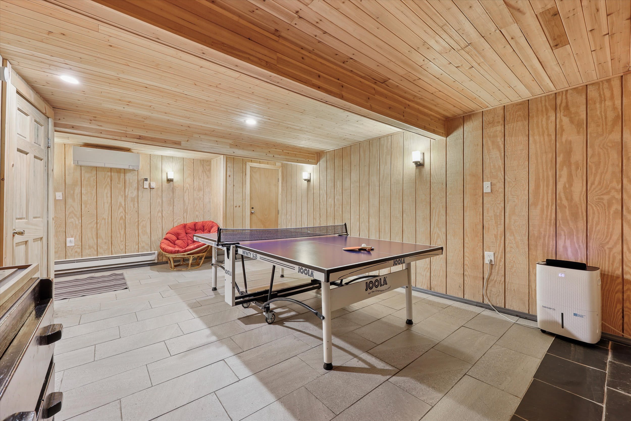 Another view of the game room with a cozy chair perfect for watching matches unfold.