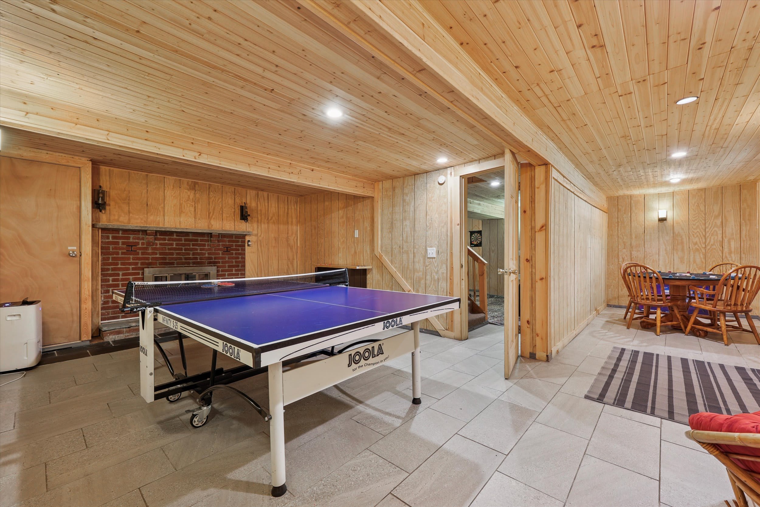 Keep the competition going in the game room with a ping pong table and cozy seating.