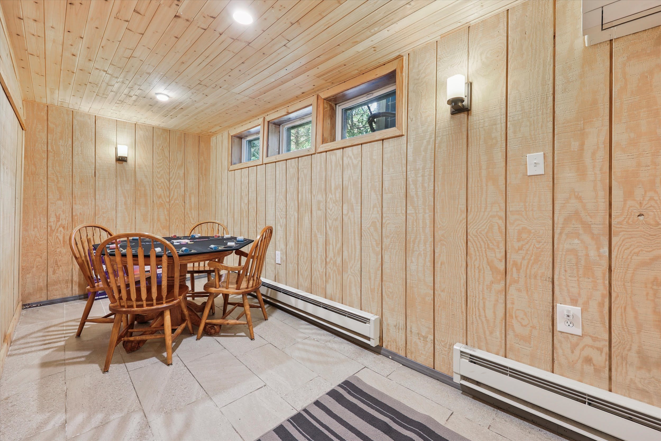 Pull up a chair at the wooden game table for cards, puzzles, or board games by the window.