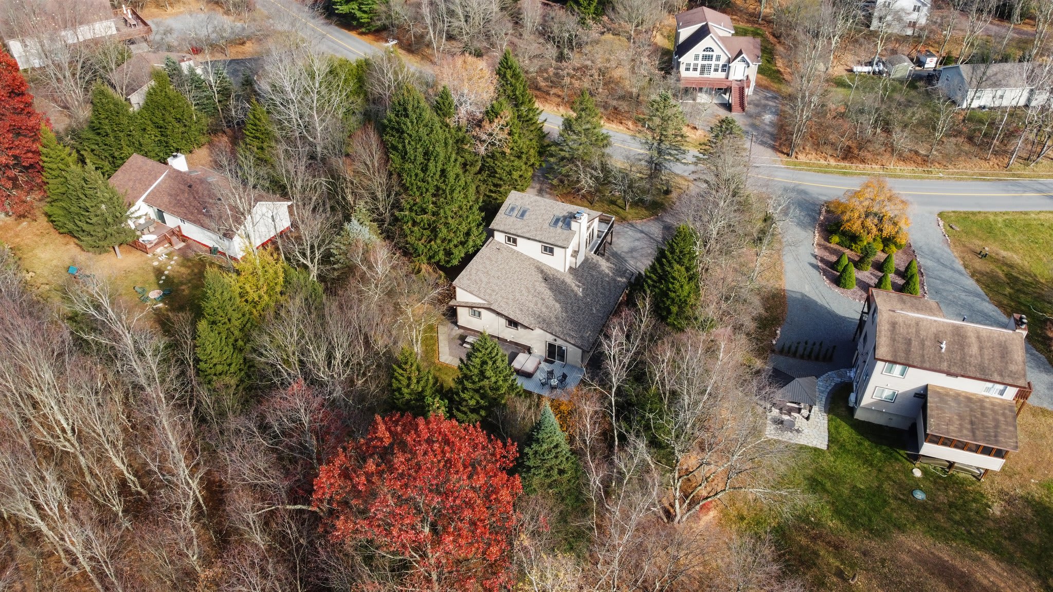 From above, see the spacious property with mature trees and easy access from the road.